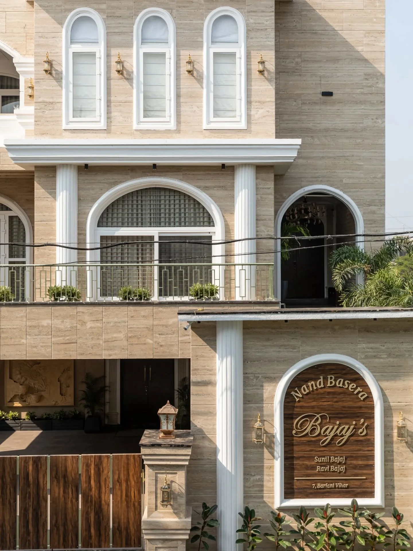 The kind of house that doesn&rsquo;t believe in subtle entrances. Arches frame the facade, pillars hold their ground with quiet confidence, and every room continues the narrative indoors through carved details, velvet textures, marble surfaces, and w