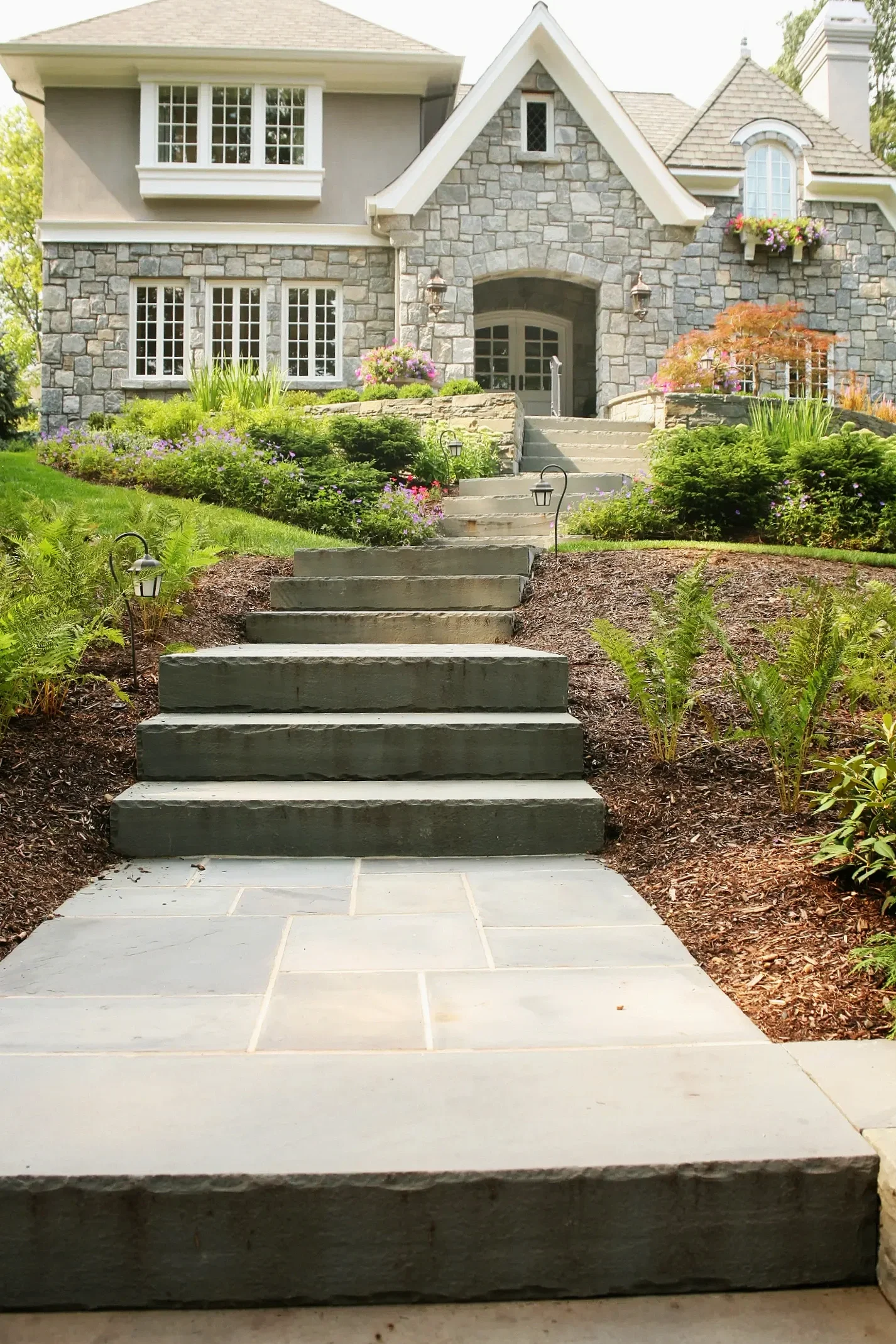 formal courtyard design with a central paver walkway and symmetrical landscaping in Ho-Ho-Kus, NJ