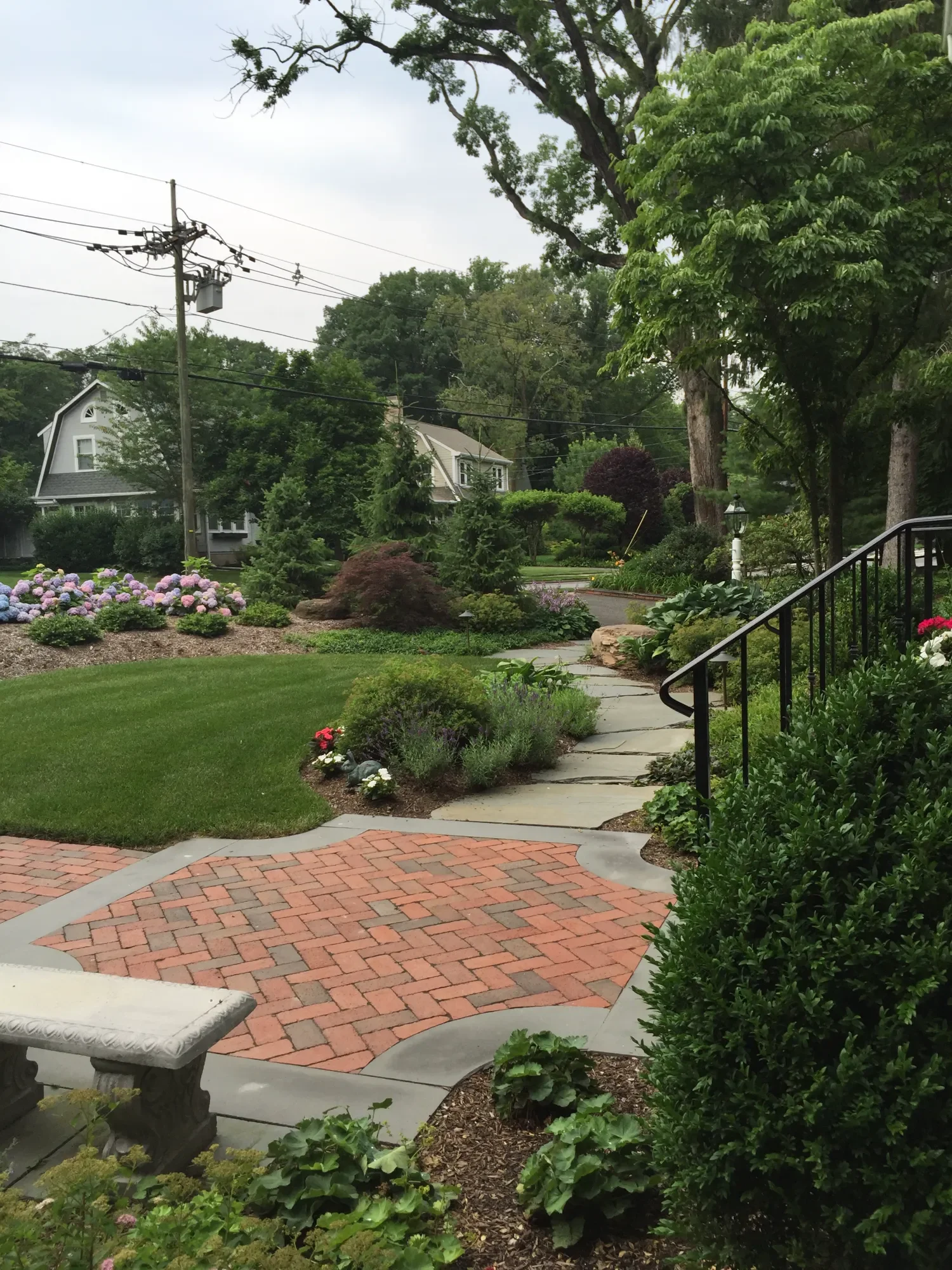 handcrafted paver walkway blending brick accents with natural stone in Saddle River, NJ
