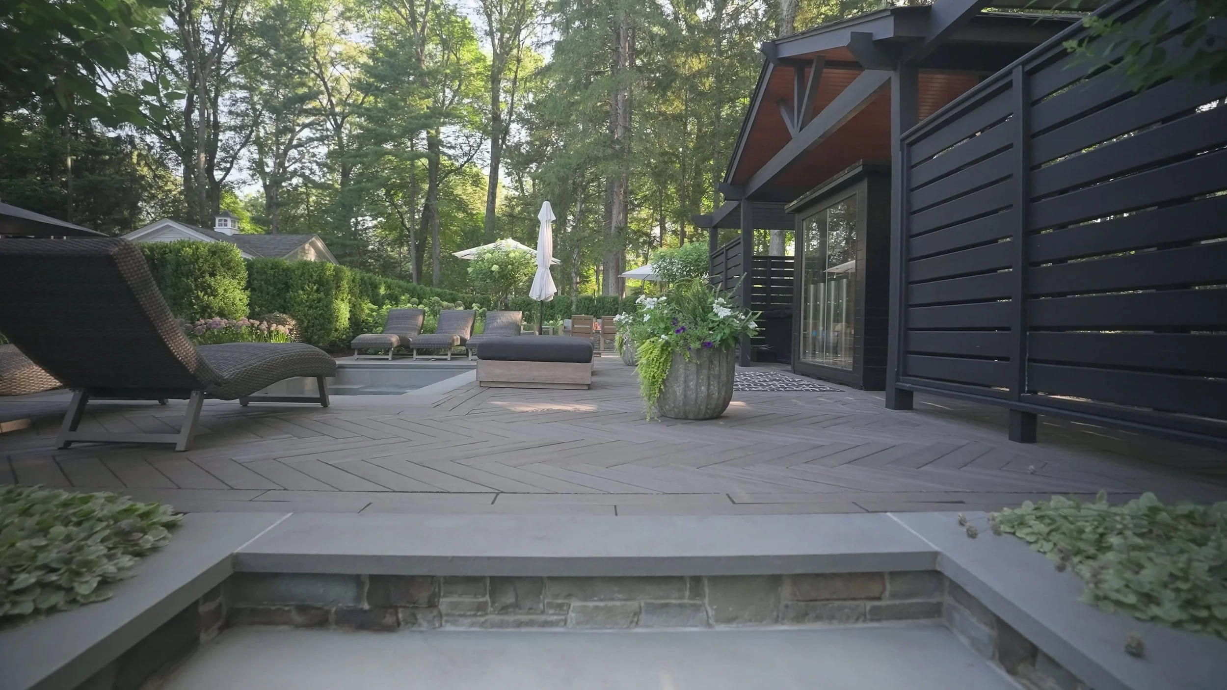 Modern landscape design featuring a tranquil inground pool in Saddle River, NJ