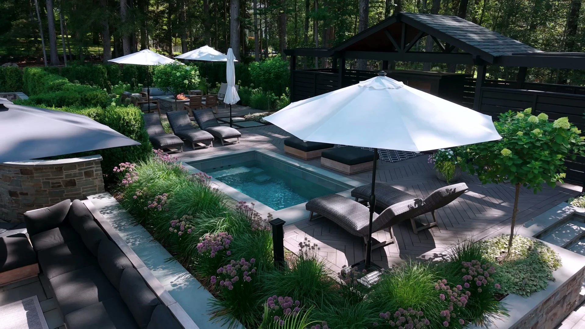 Elegant fiberglass pool surrounded by natural stone paver patio in Wyckoff, NJ