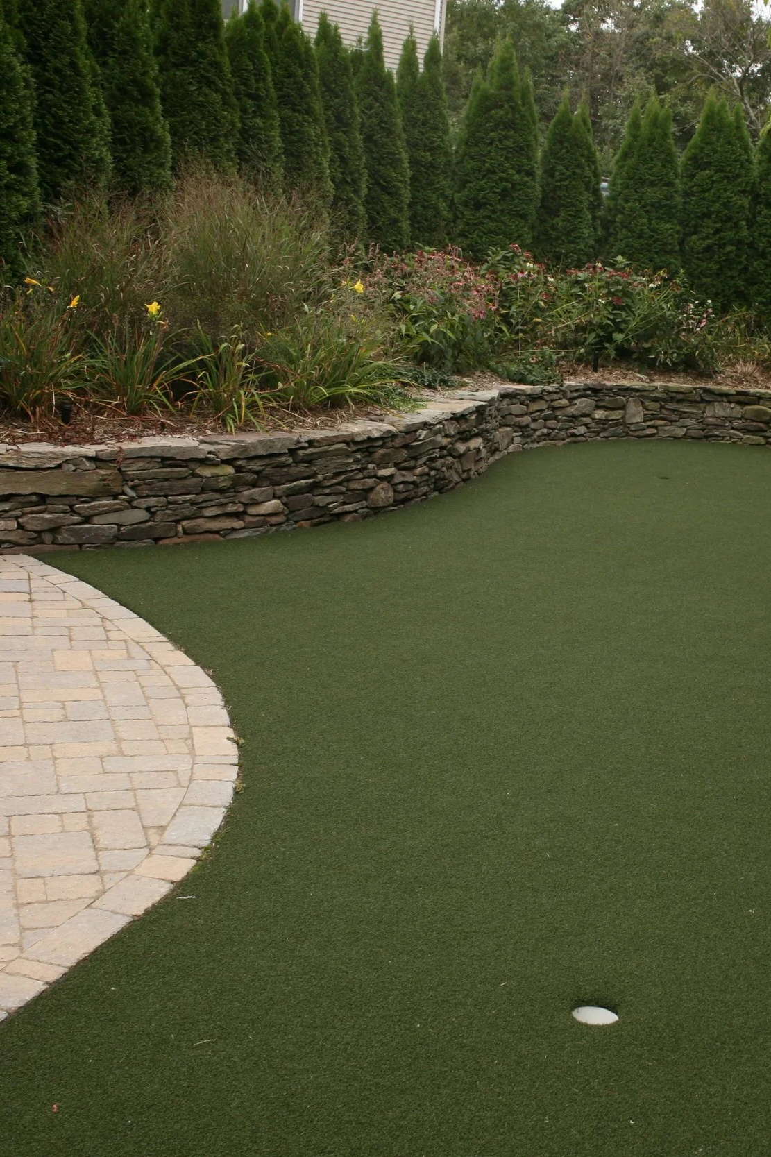 A custom backyard putting green installation designed for practice and relaxation in Allendale, NJ