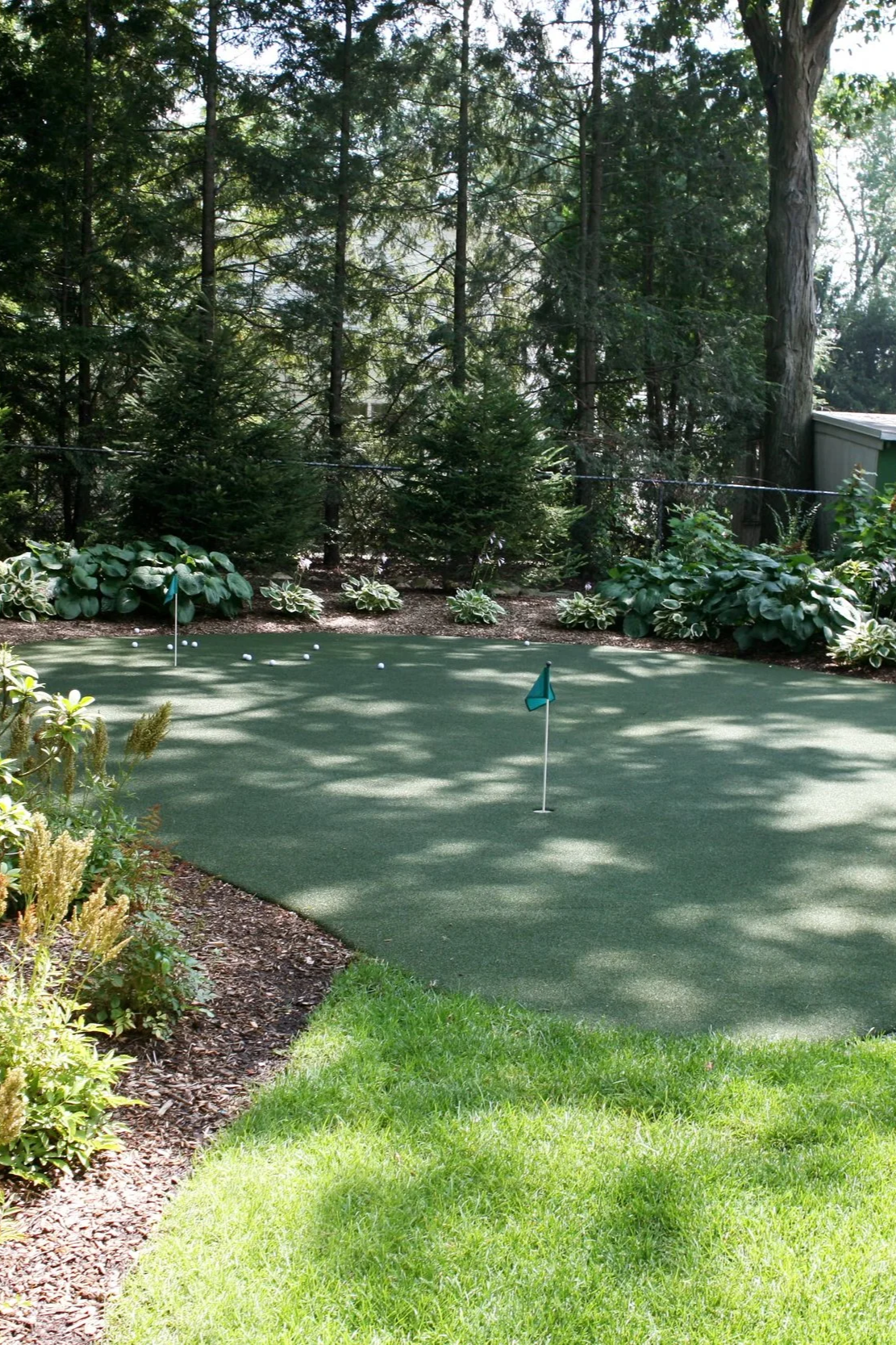 A stunning outdoor living space with backyard putting green installation for practice and entertainment in Woodcliff Lake, NJ