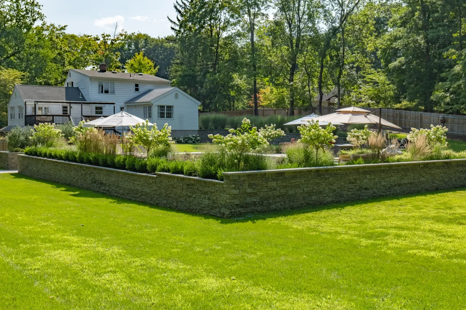 Retaining wall paired with stone steps to connect different yard elevations in Ridgewood, NJ
