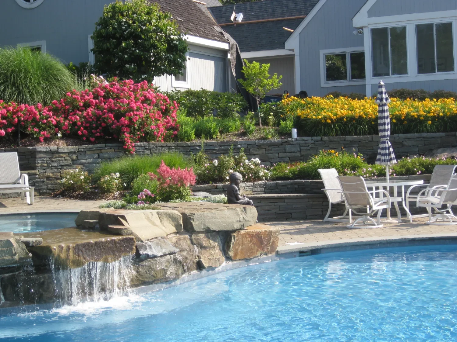 Retaining wall with clean stone lines enhancing a traditional backyard layout in Oradell, NJ