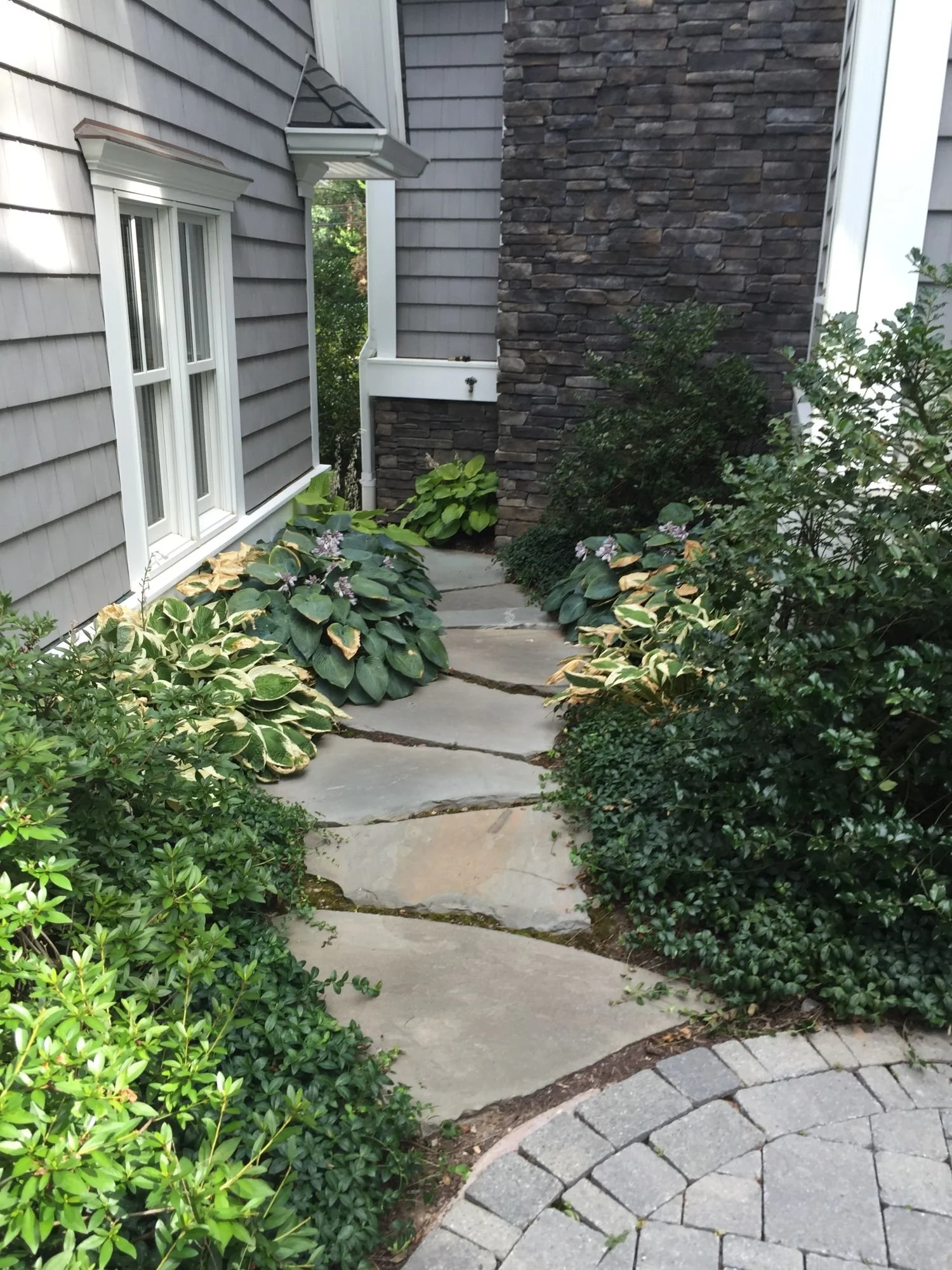 Informal stone walkway designed as a natural pathway across the yard in Franklin Lakes, NJ