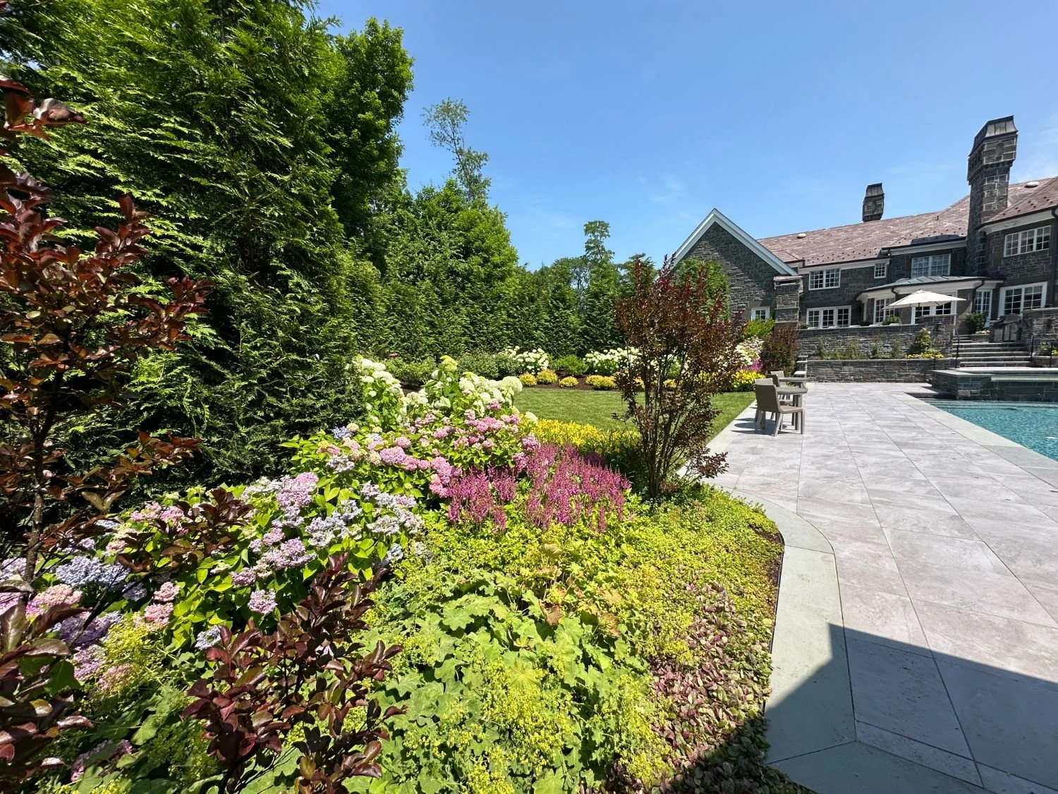 Carefully selected plantings creating visual rhythm throughout a garden room in Ramsey, NJ