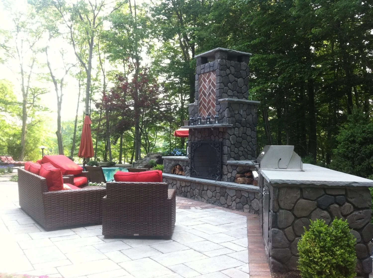 Custom masonry creates a fire pit integrated into the patio layout in Glen Rock, NJ