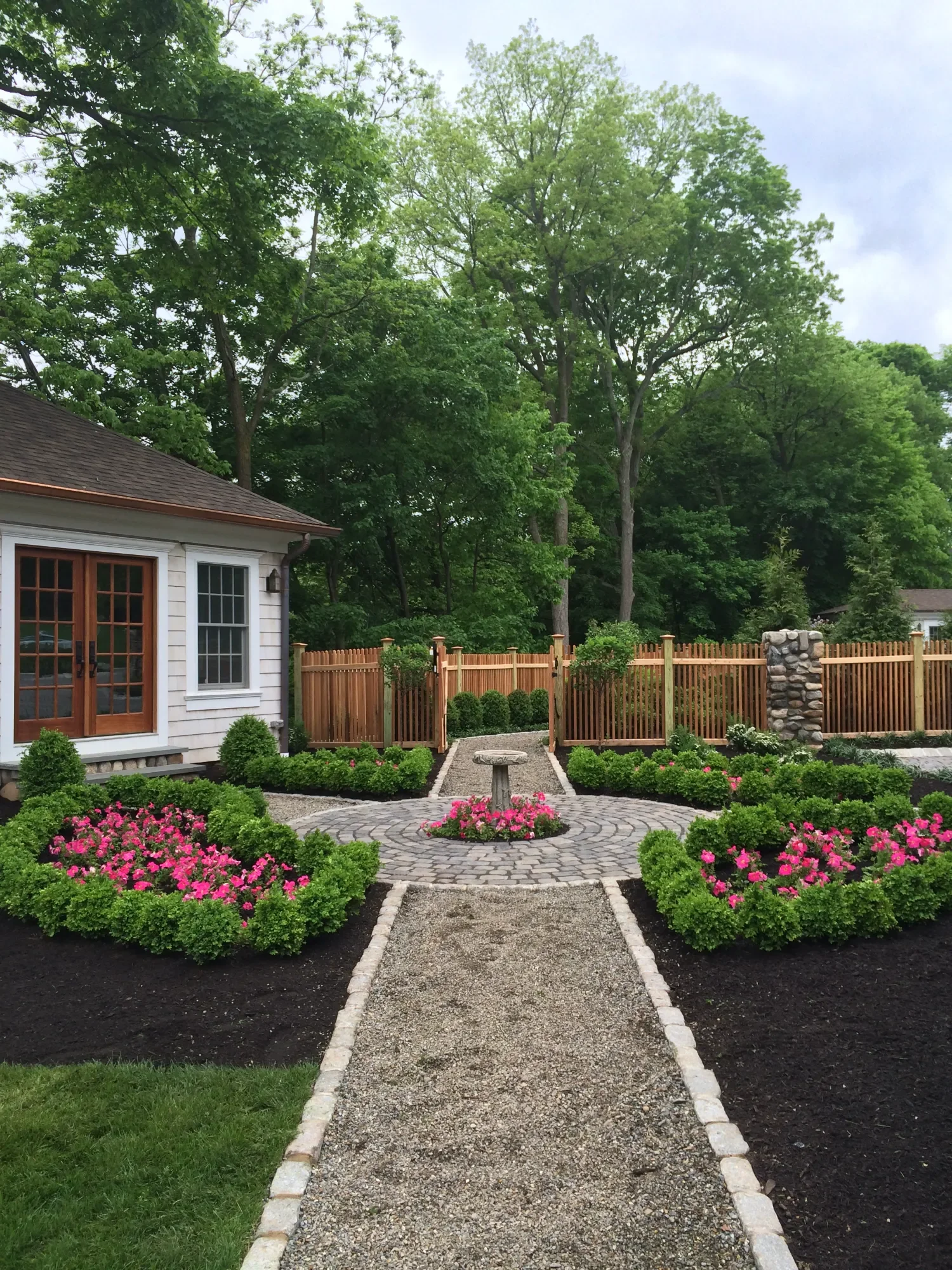 paver walkway connecting garden beds to a traditional home entrance in Saddle River, NJ