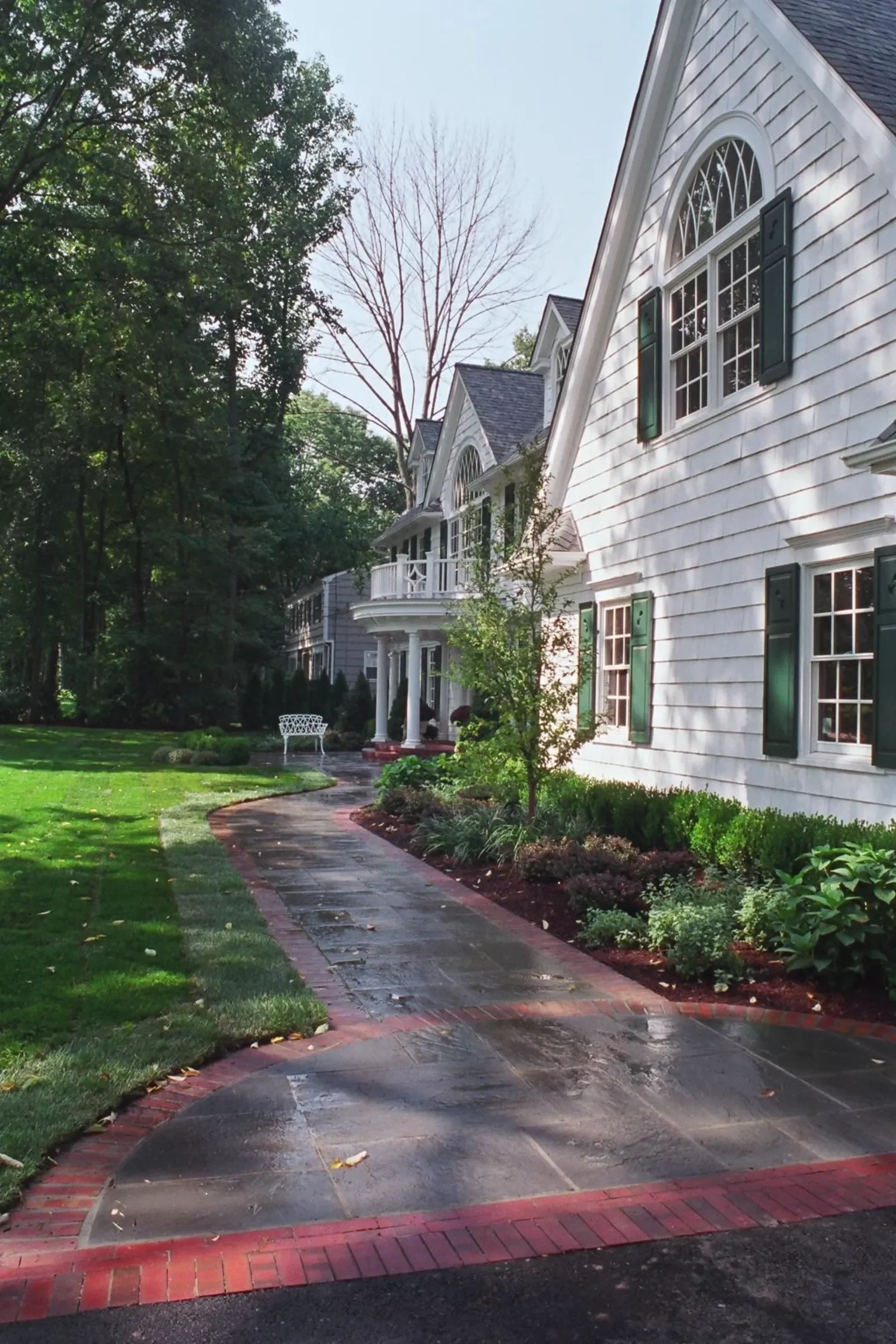 welcoming front approach with a gently winding paver walkway in Ho-Ho-Kus, NJ