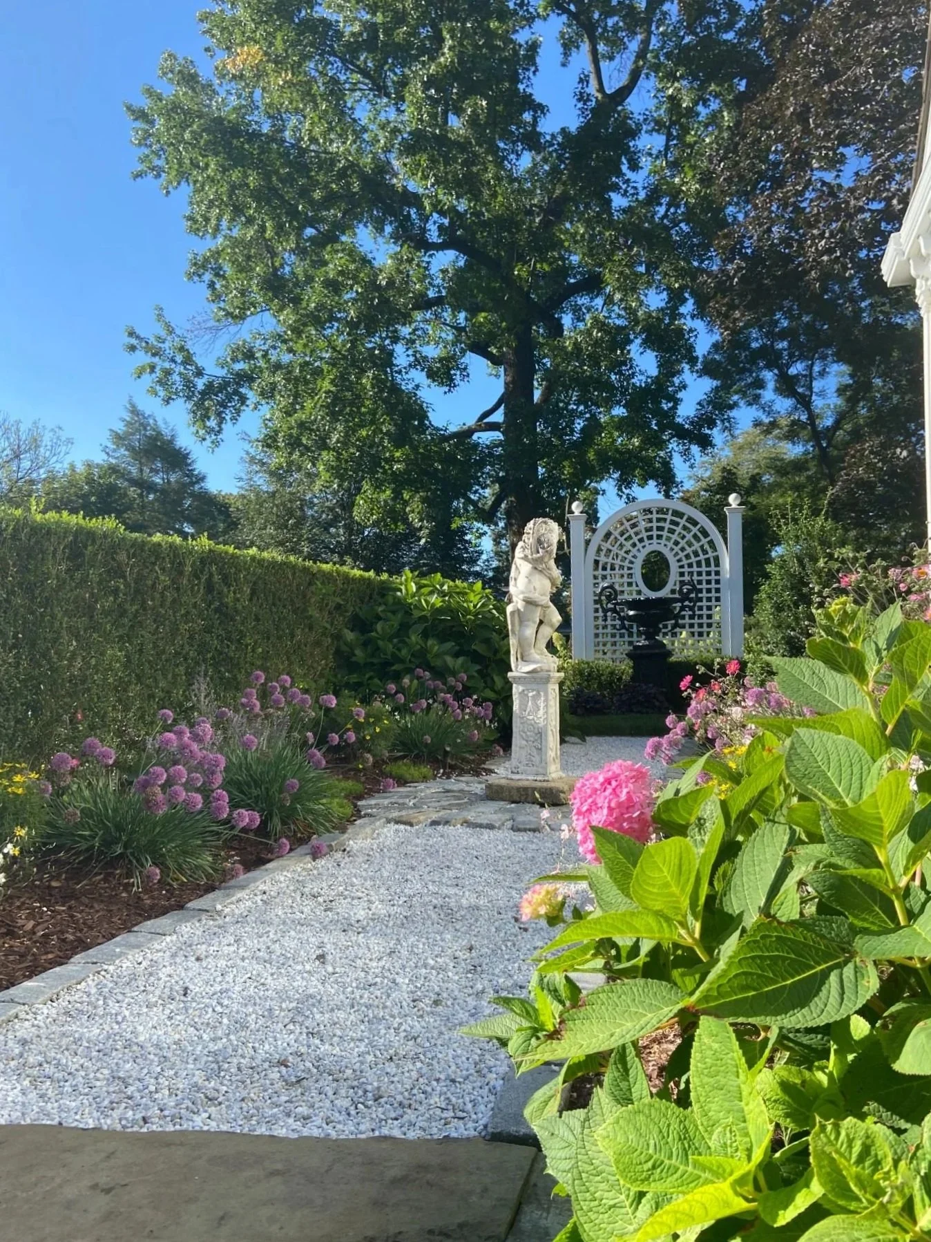 Flowering plantings defining outdoor rooms along a residential landscape in Westwood, NJ