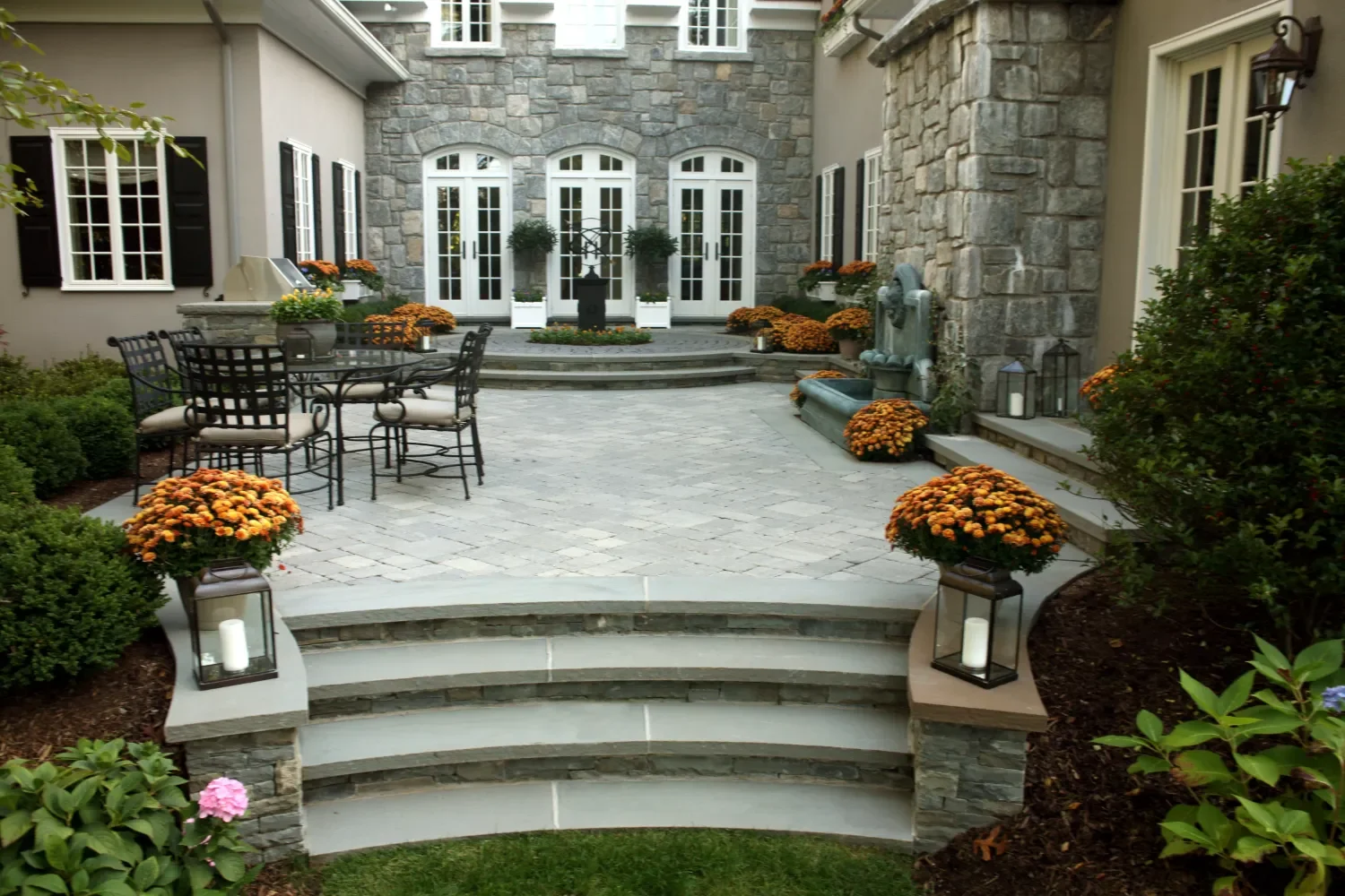 curved paver walkway leading to a stone entry courtyard in Ho-Ho-Kus, NJ