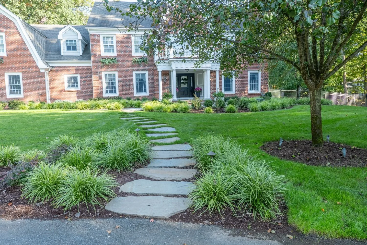 Garden room framed by evergreen plantings for four-season interest in Ramsey, NJ