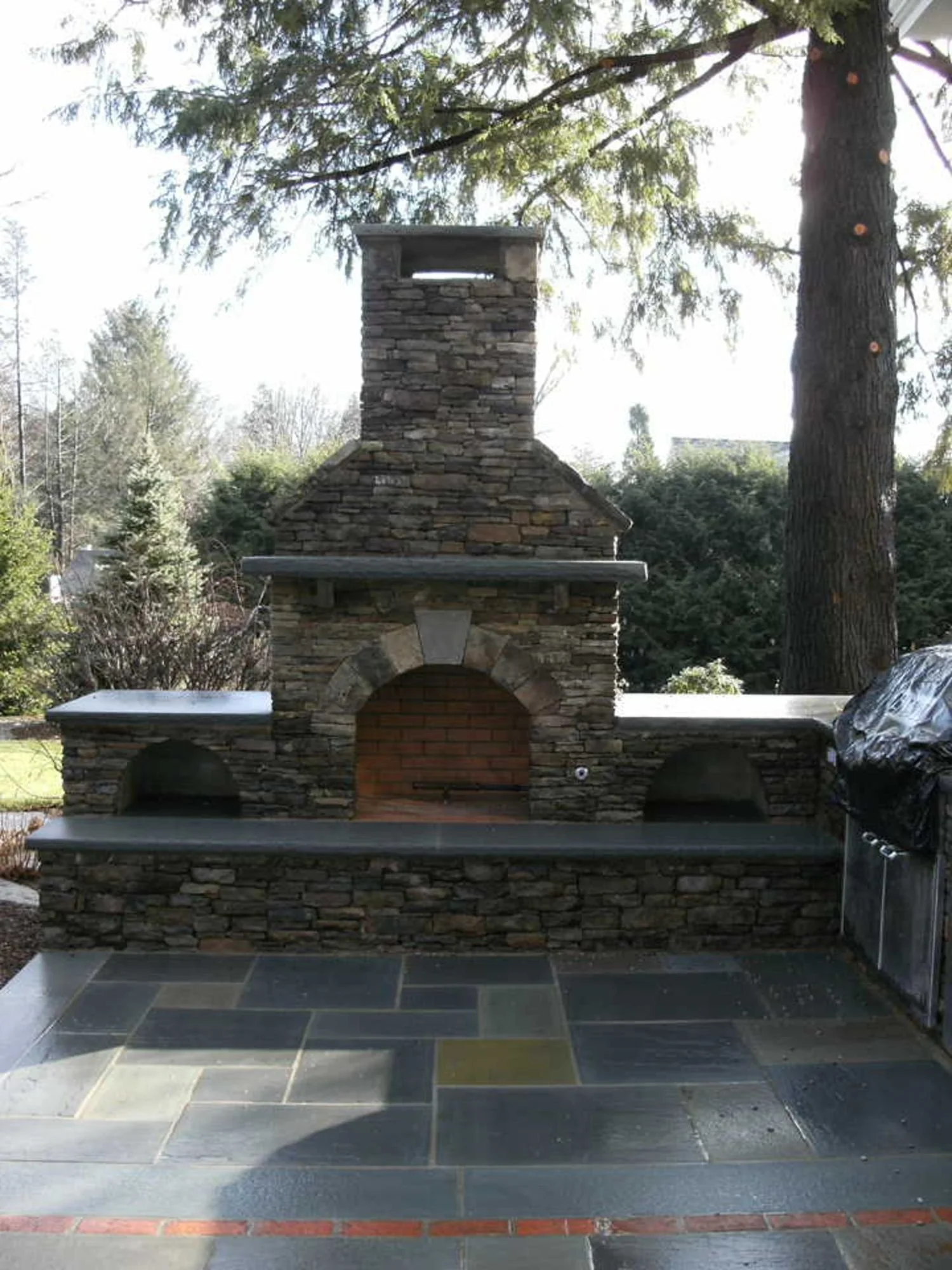 An outdoor gathering space designed around a fire pit in Wyckoff, NJ