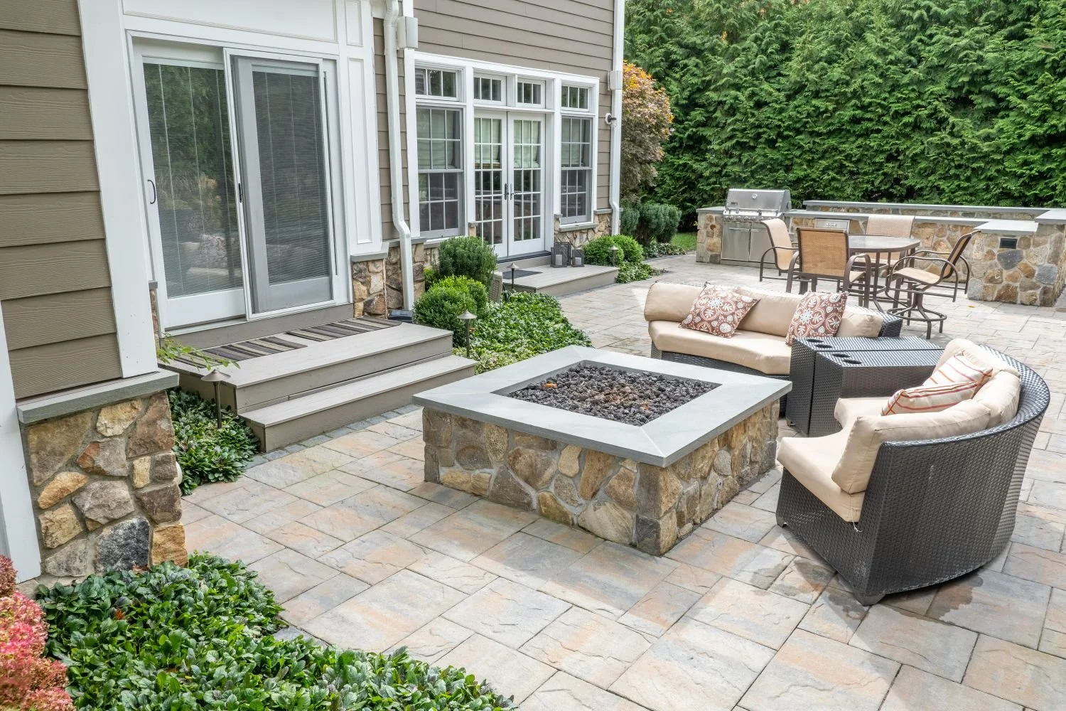 A wood-burning fire pit positioned as the focal point of the patio in Glen Rock, NJ