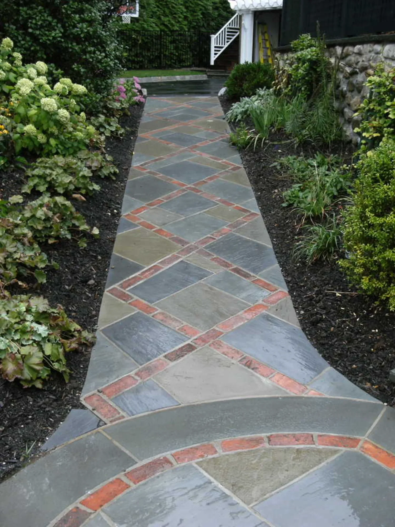 brick and stone paver walkway detail with curved edging in Ridgewood, NJ