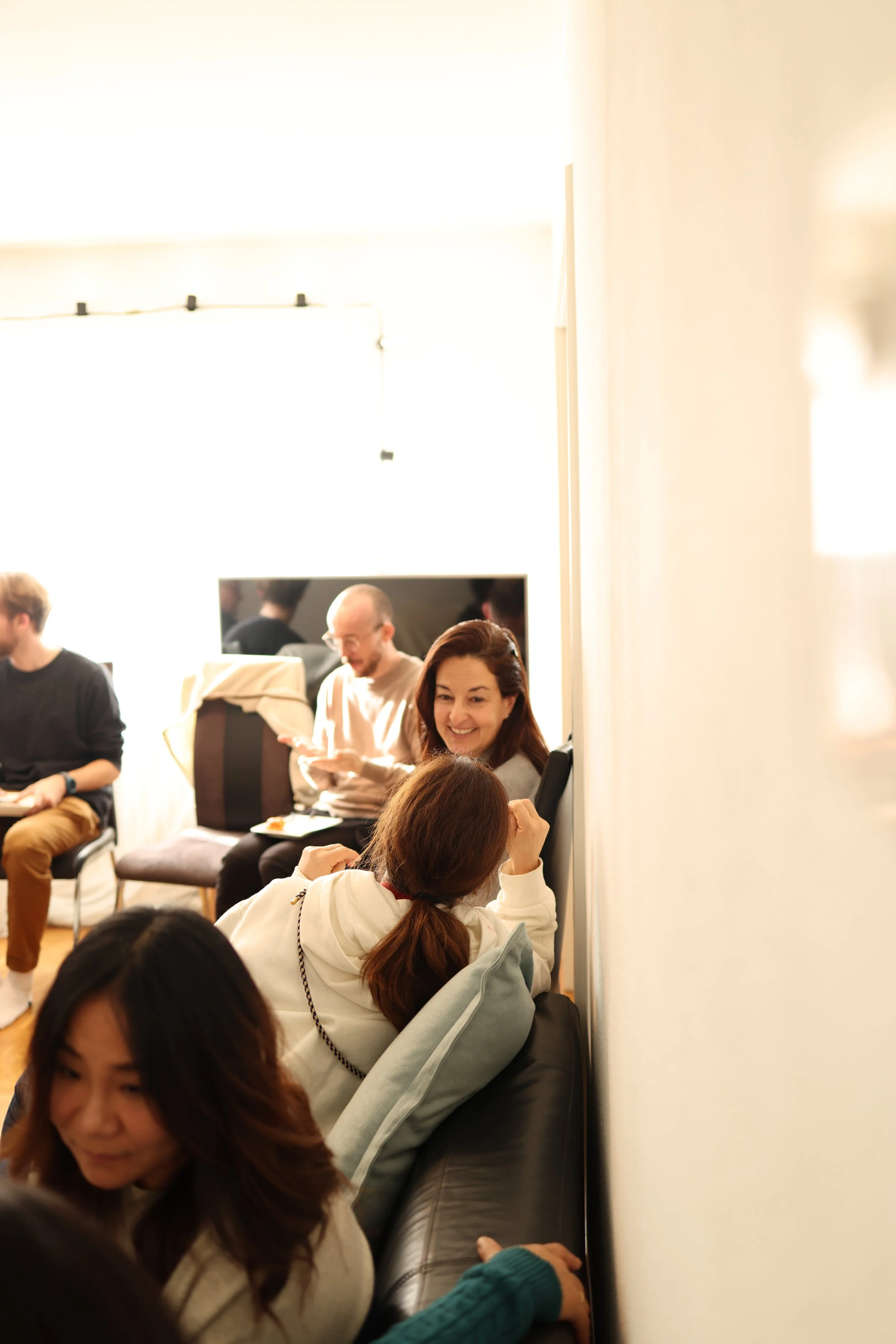 A city street scene in autumn with a tram on tracks, trees with yellow leaves, and a Louis Vuitton store in a historic building.