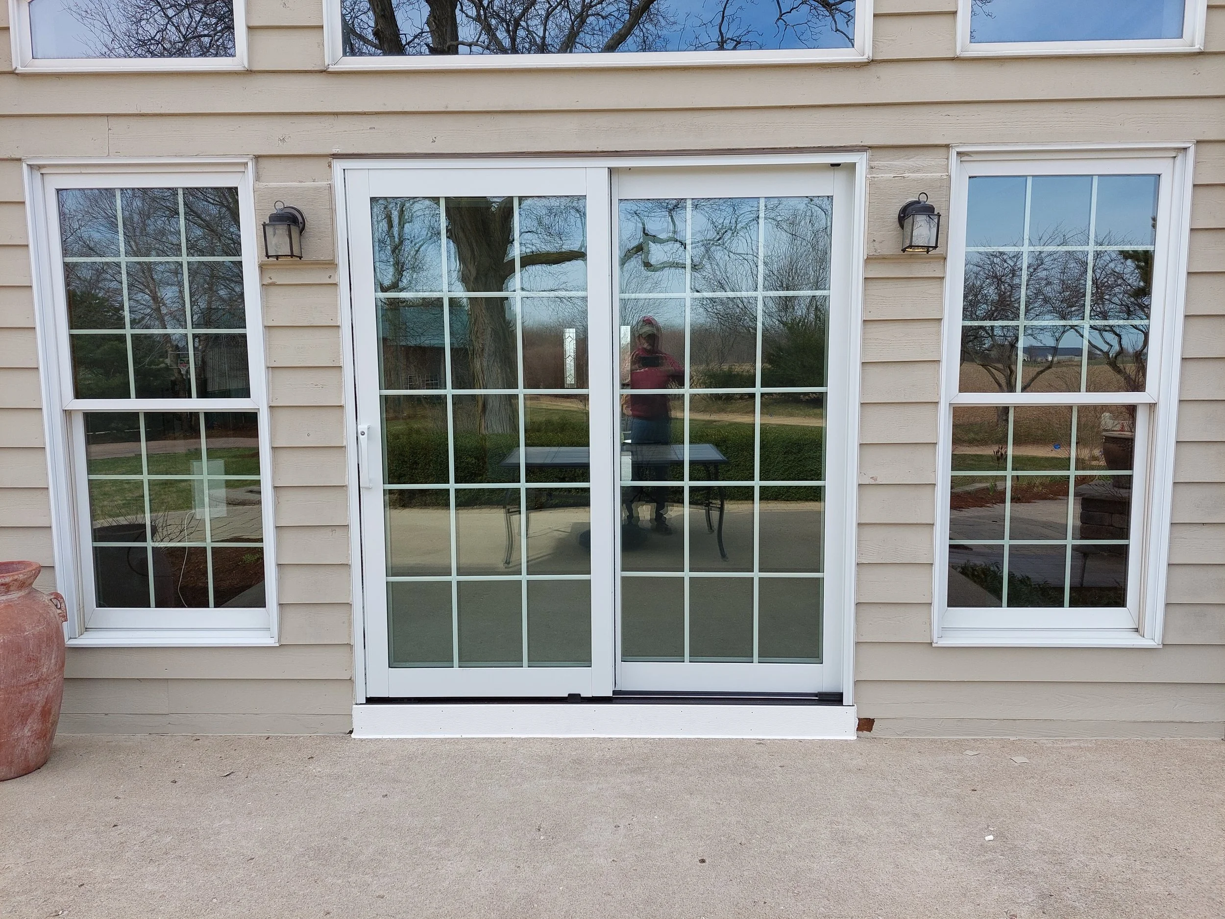 Replacement Pella Low E sliding glass doors with white frames and internal grid pattern.