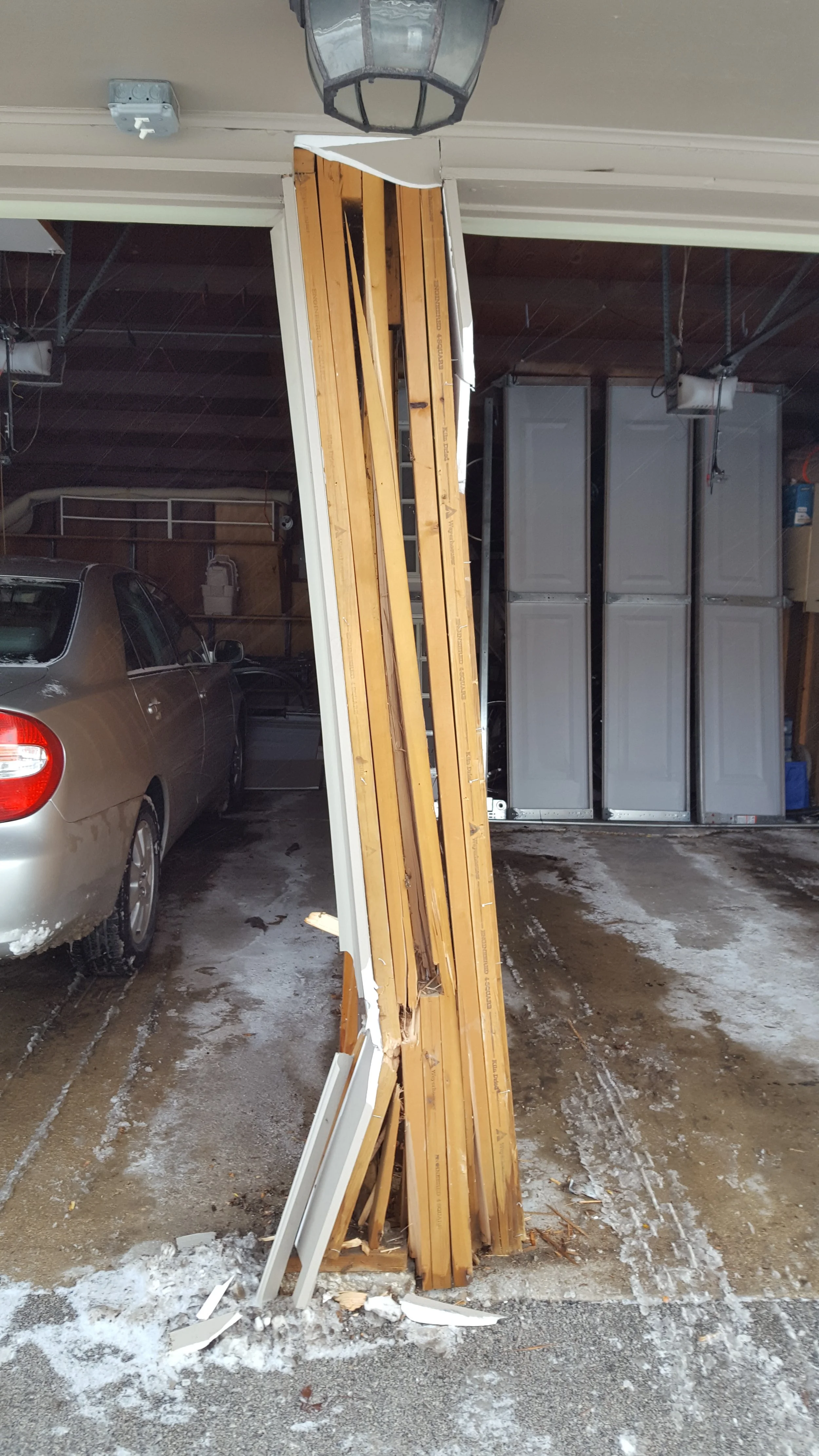 Damaged garage door frame before repair 
