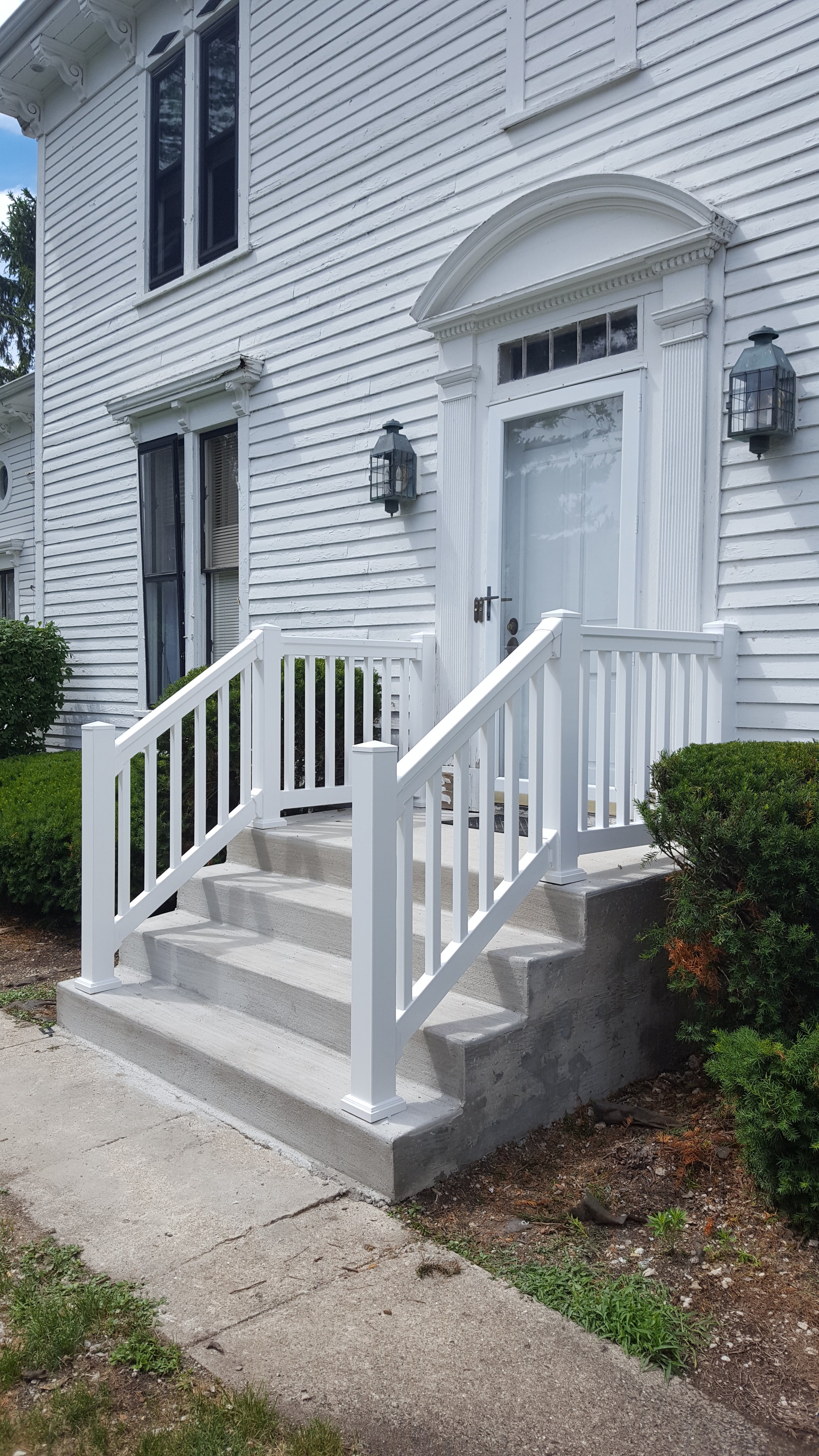White front porch with stairs and railing