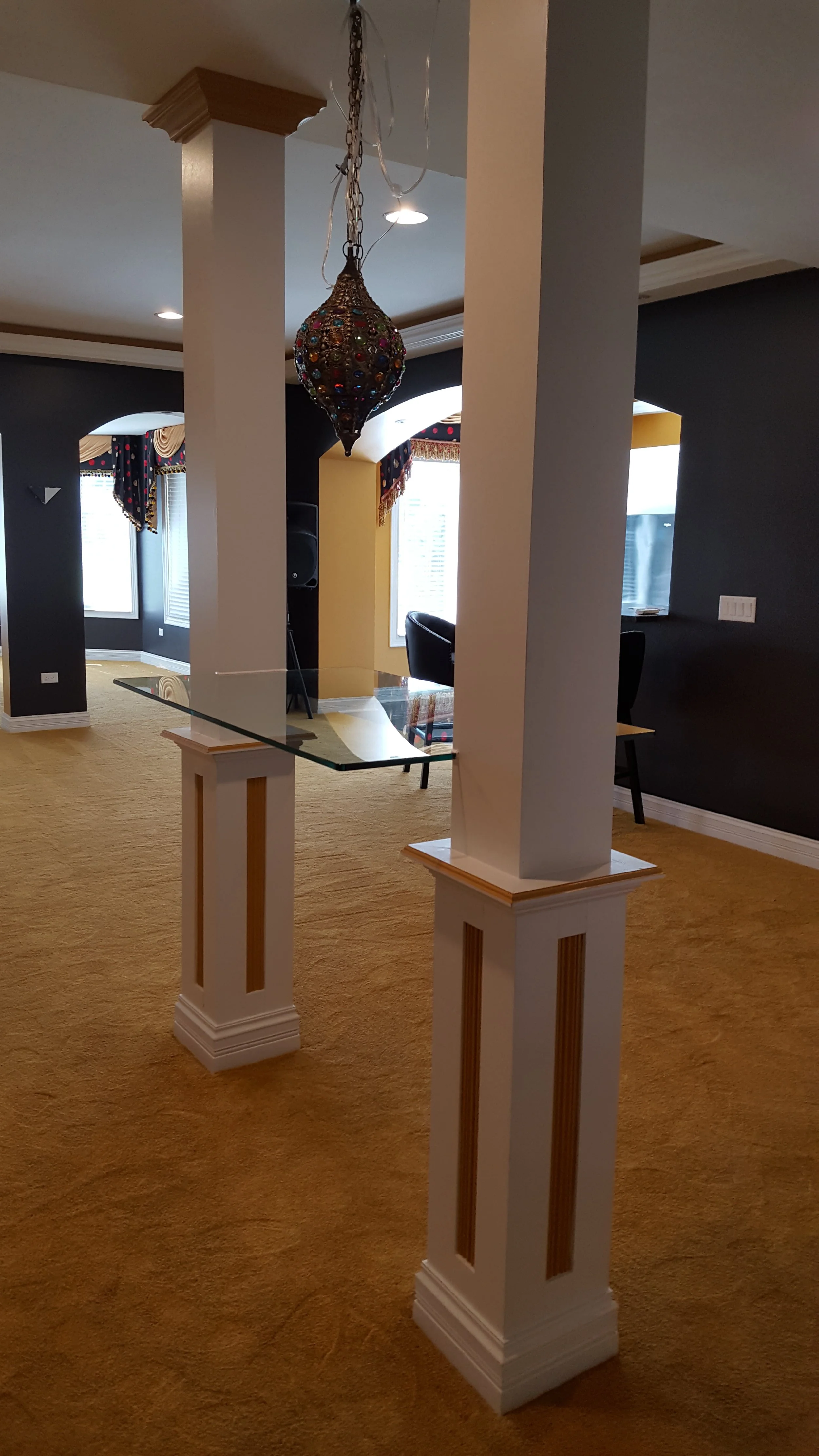 Custom thick glass shelf installed between two pillars