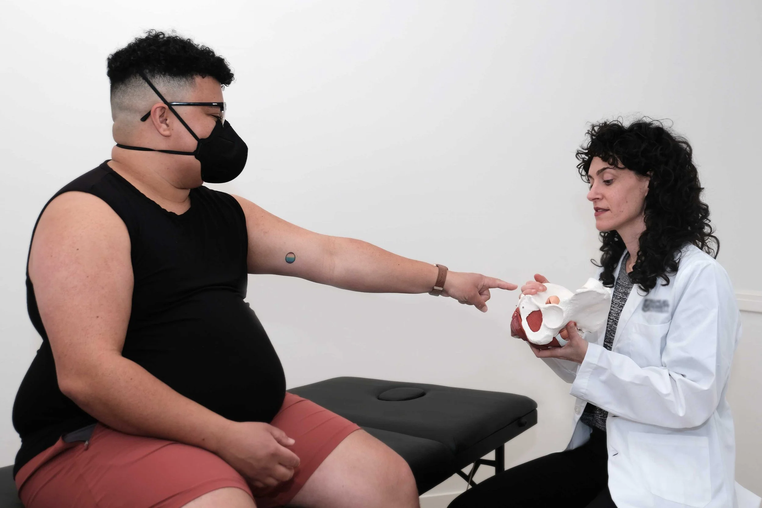 describing pelvic floor muscle function to qpoc patient wearing mask for covid safety in the pelvic floor clinic