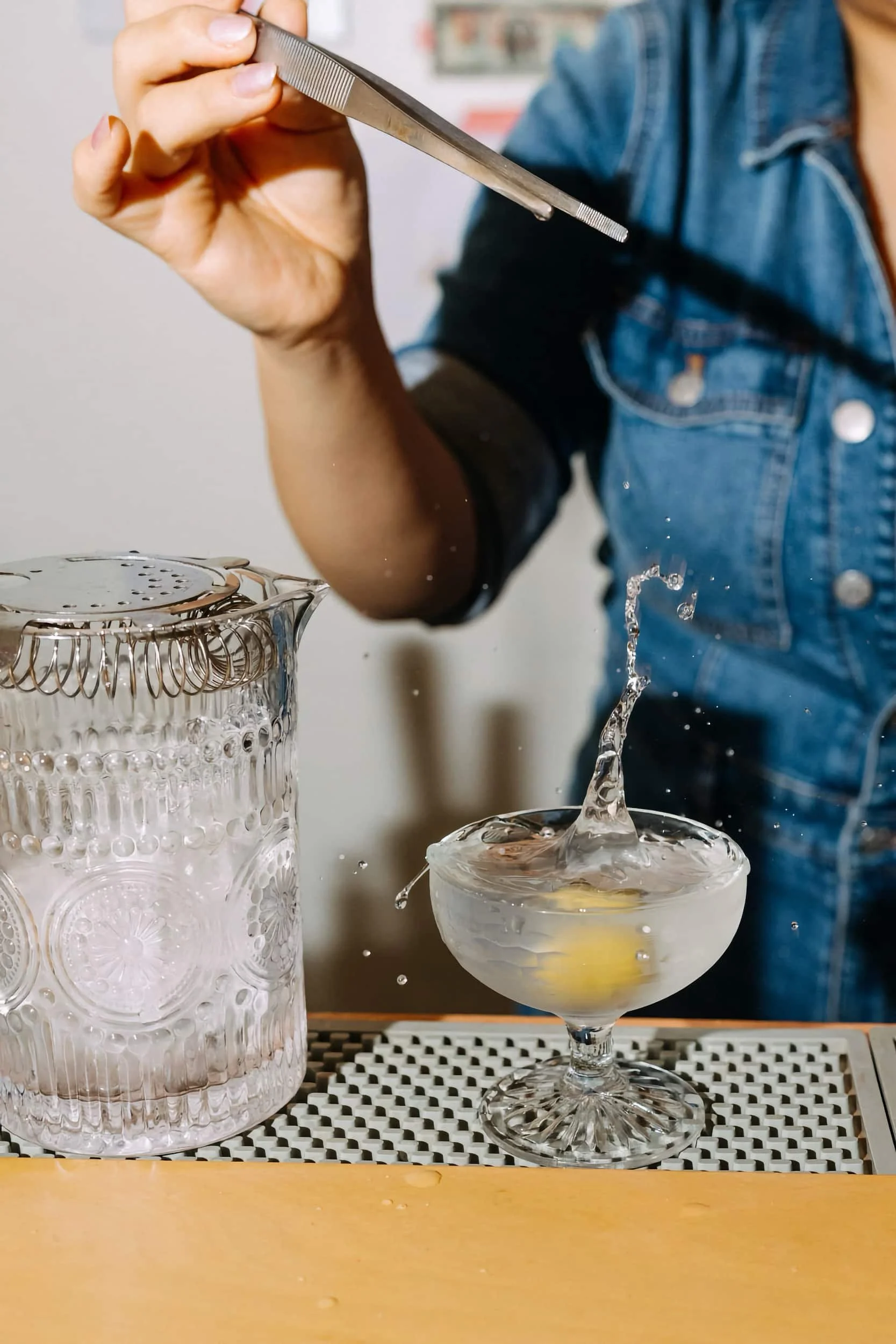 A closeup of a person mixing a drink