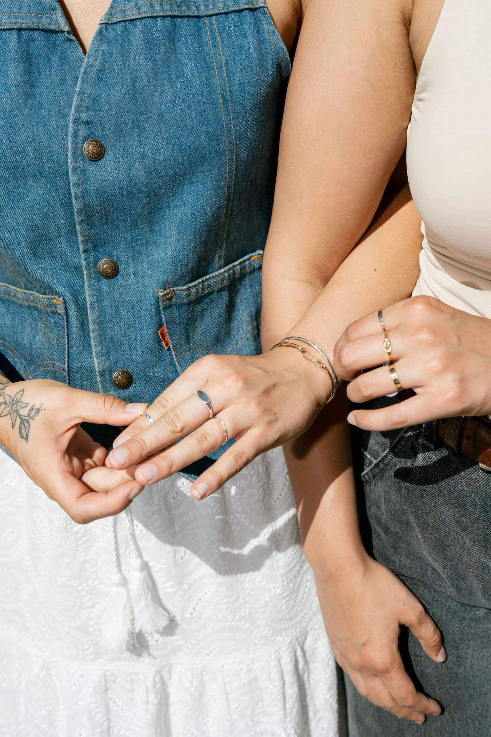 A closeup of women with their arms intertwined