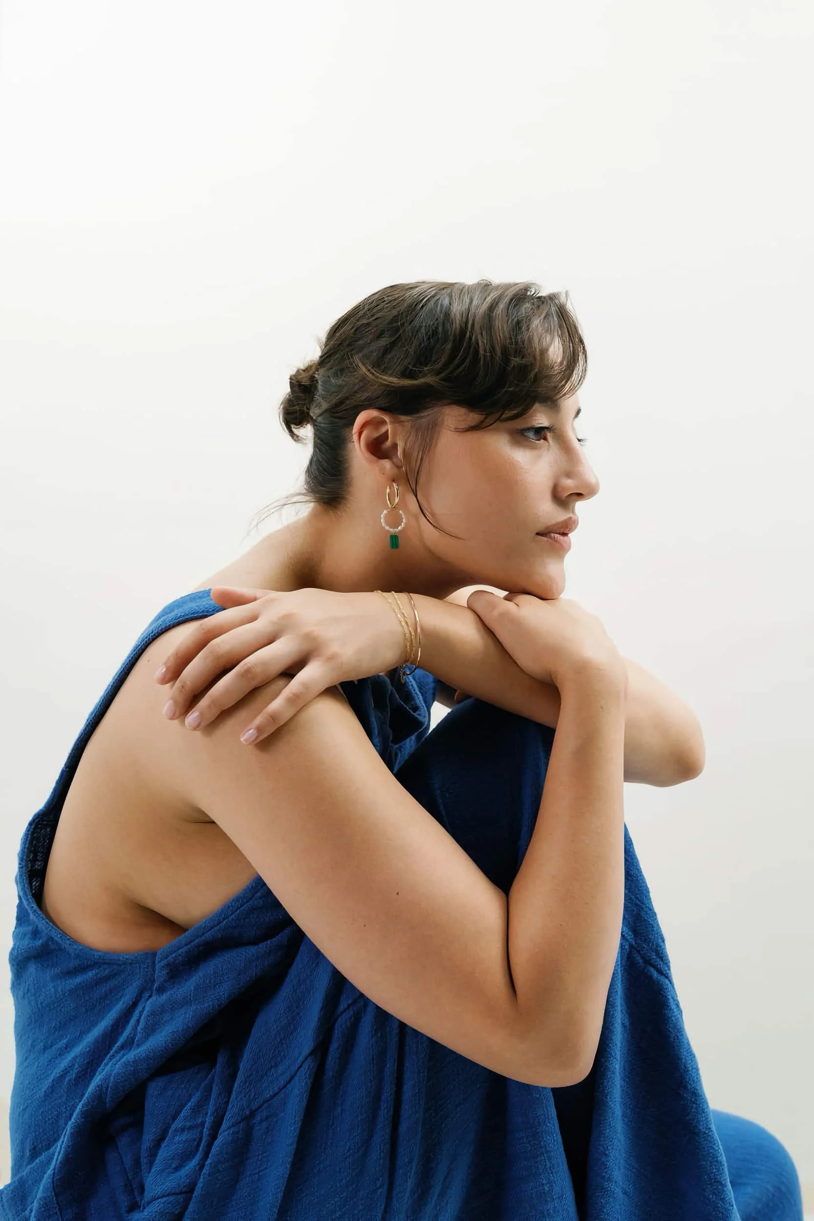 A person with their chin on their knee