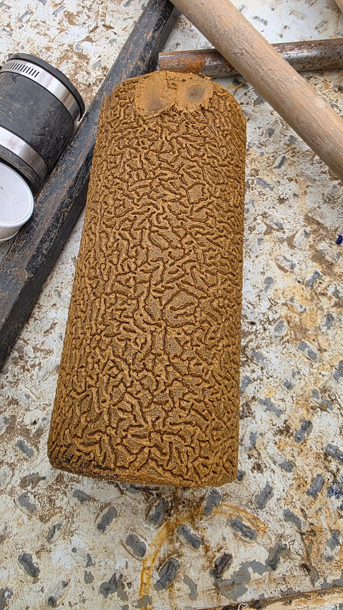 home water filter clogged with sediment and iron deposit in a wavy pattern