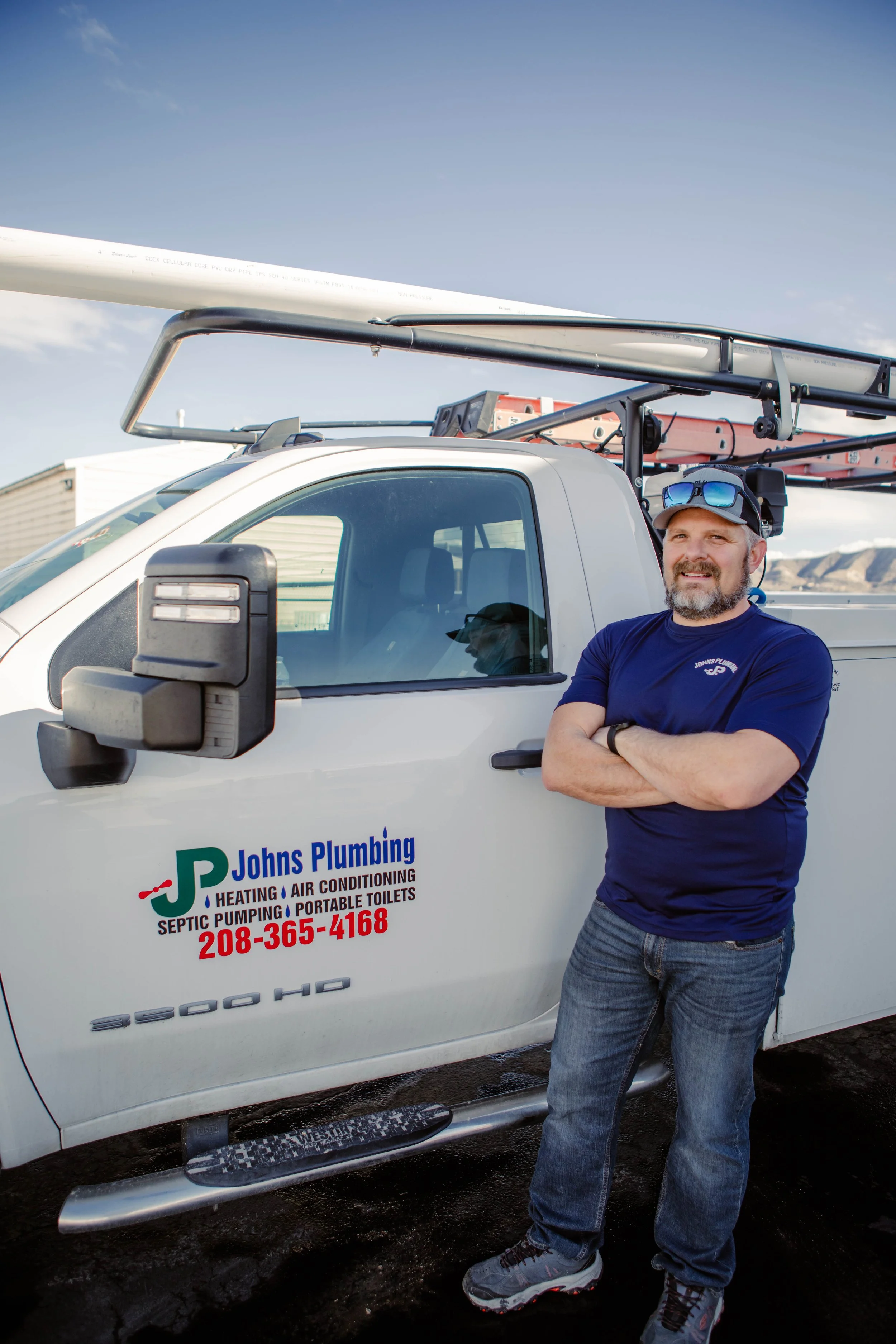 Levi Johns Owner next to a white work truck