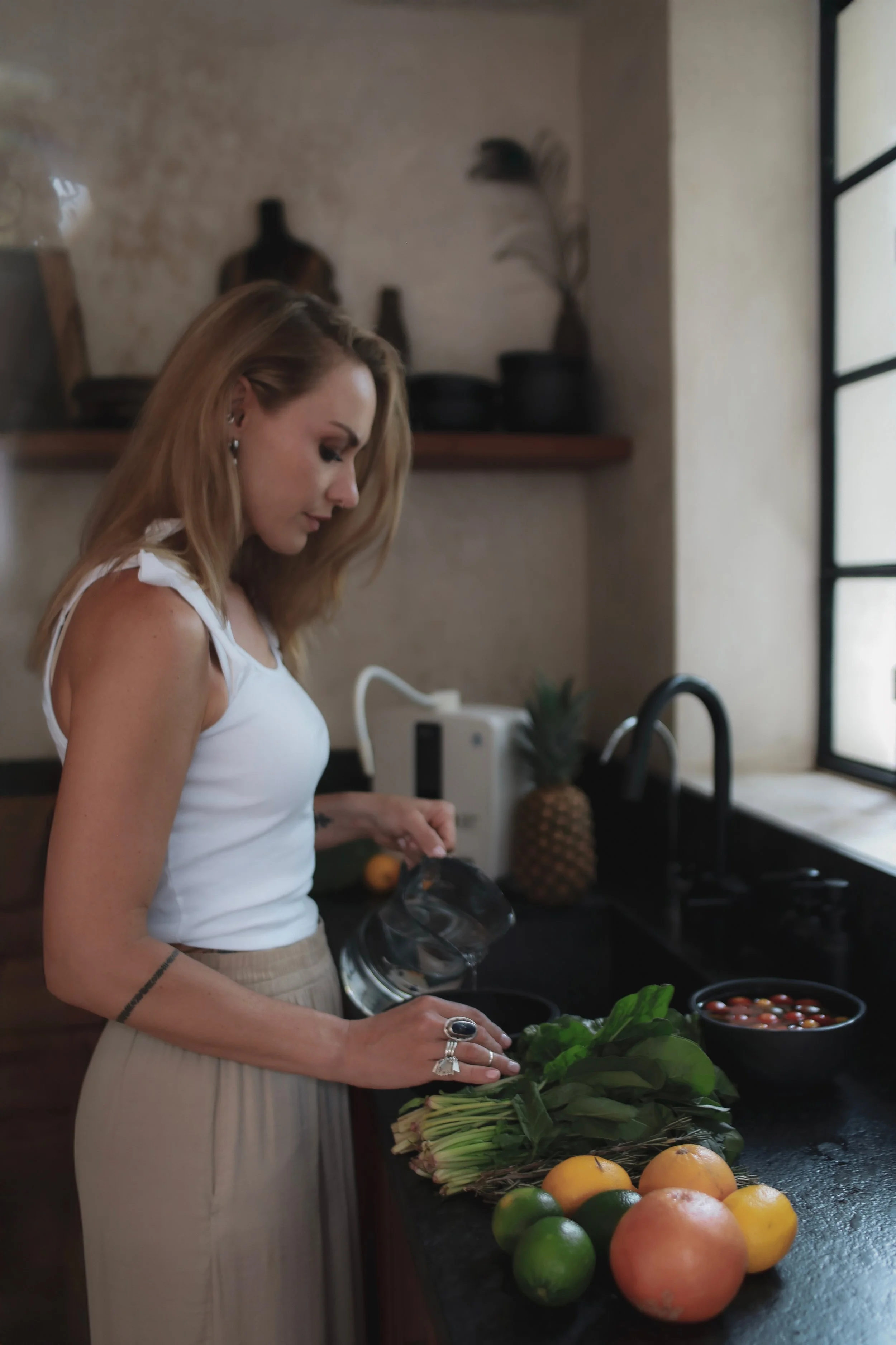 Elina, founder of AWÜA, photographed beside a Kangen Water® system.