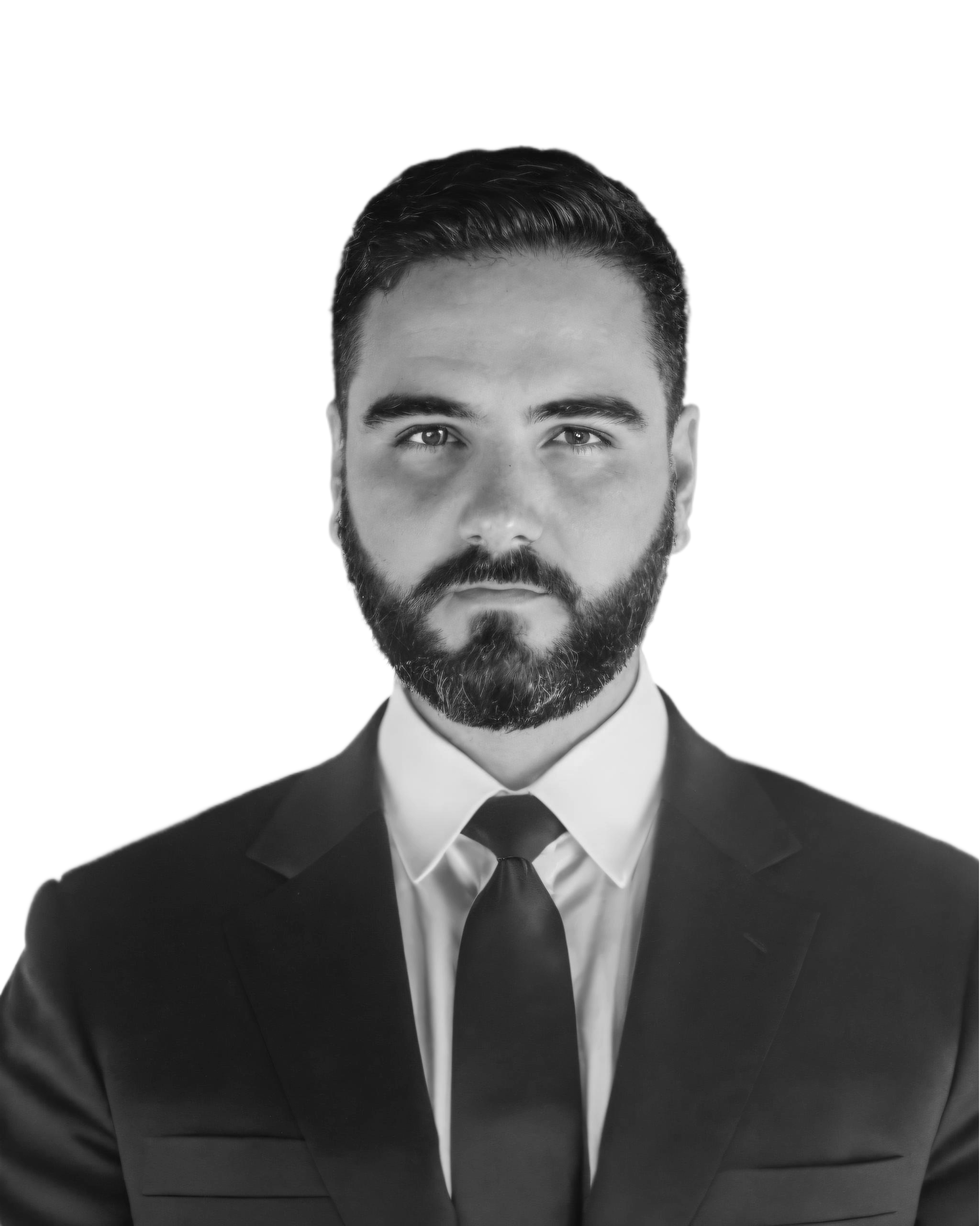 Black and white portrait of a man in a suit and tie, smiling.