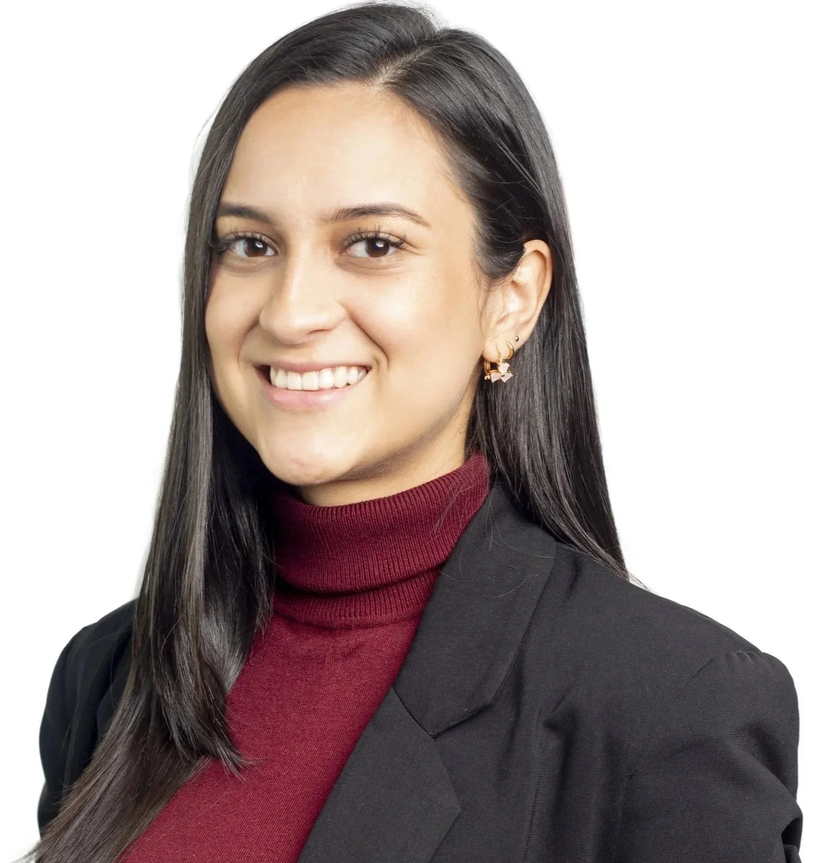 Black and white portrait of a young woman with long hair, wearing a turtleneck and blazer, smiling at the camera.