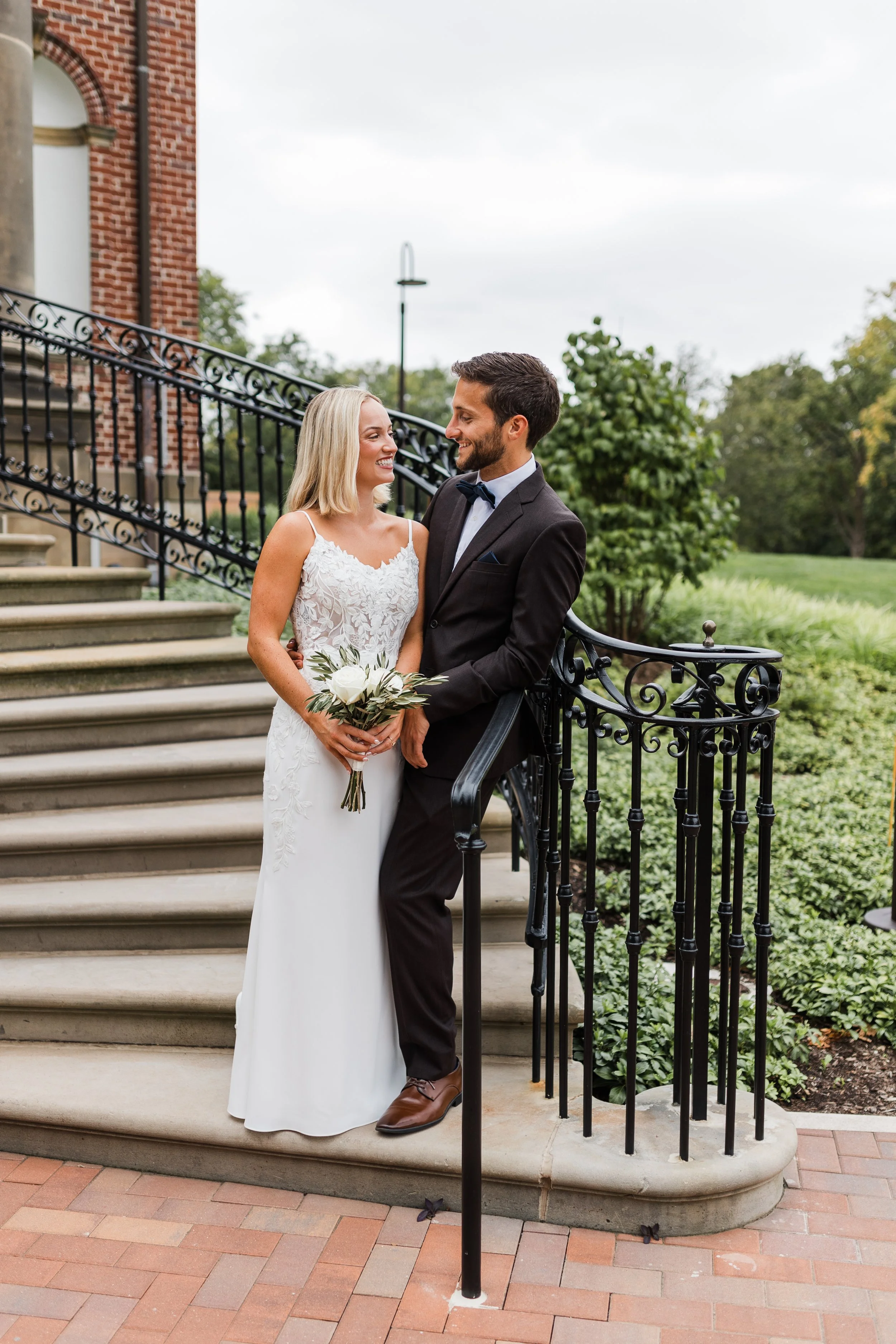 A bride and groom posing outside at the Cantigny East Lawn Gardens in Wheaton, IL, following an outdoor garden wedding ceremony coordinated by One Fine Day Events.