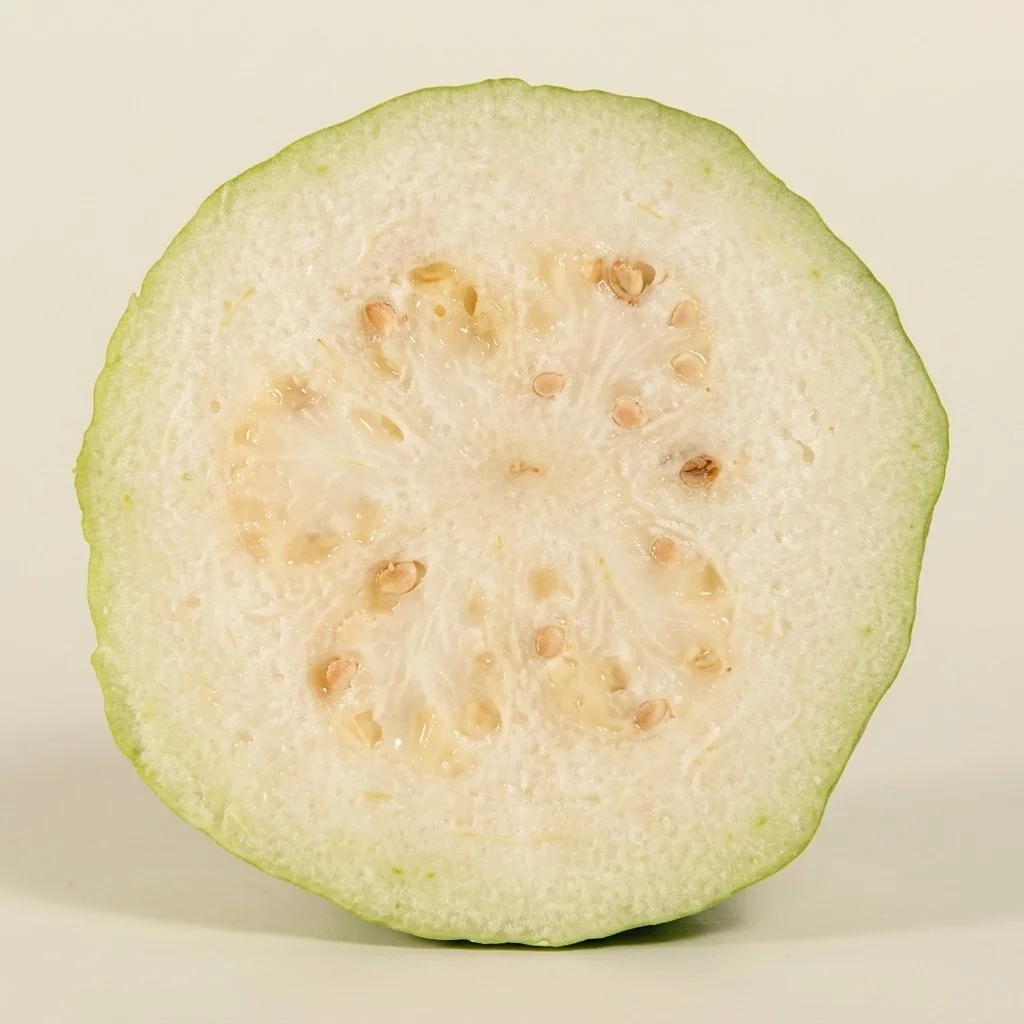 Sliced Thai white guava showing crisp white flesh and edible seeds, fresh tropical produce by Ecoripe