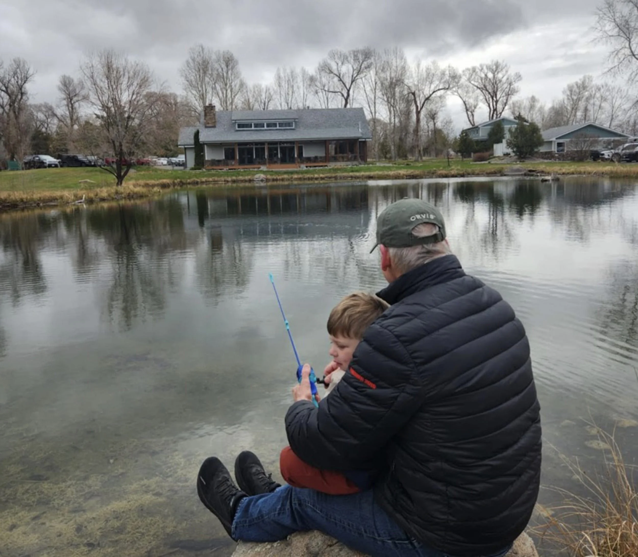 Father and child fishing by a Montana spring creek during a simple angling moment