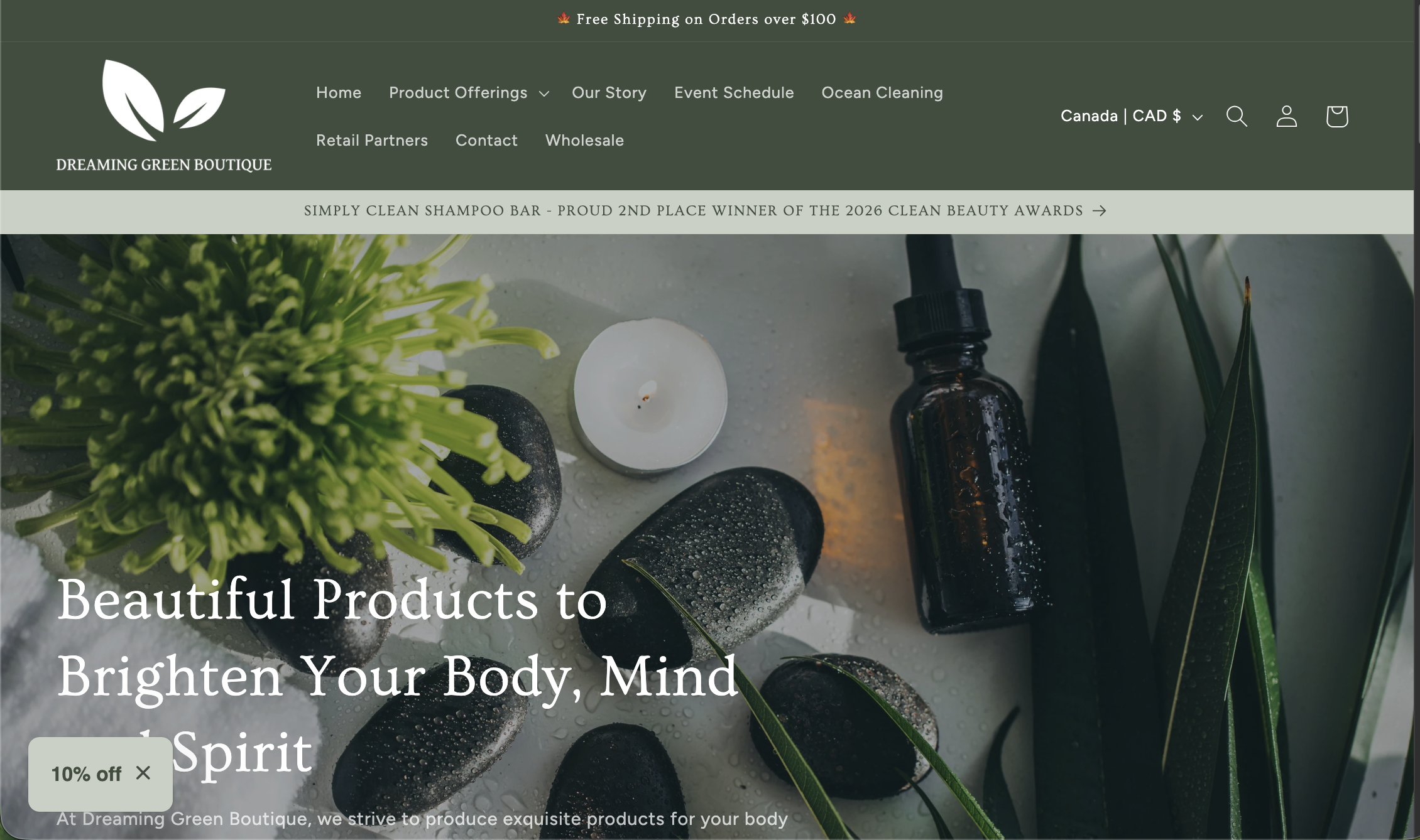 Dreaming Green Boutique website header with aloe vera slices, bubble textures, and a glass bottle on a green background.