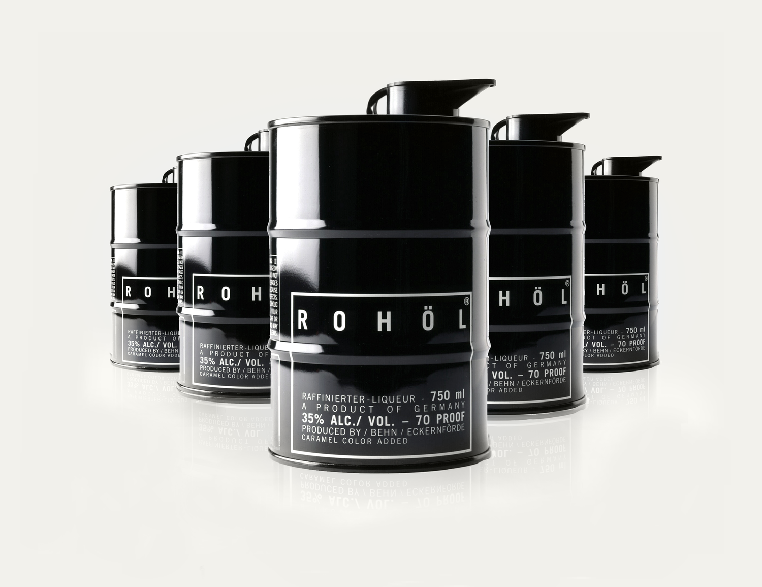 Several black cylindrical cans of Rohöl liquor arranged in a group with reflections on a white surface.