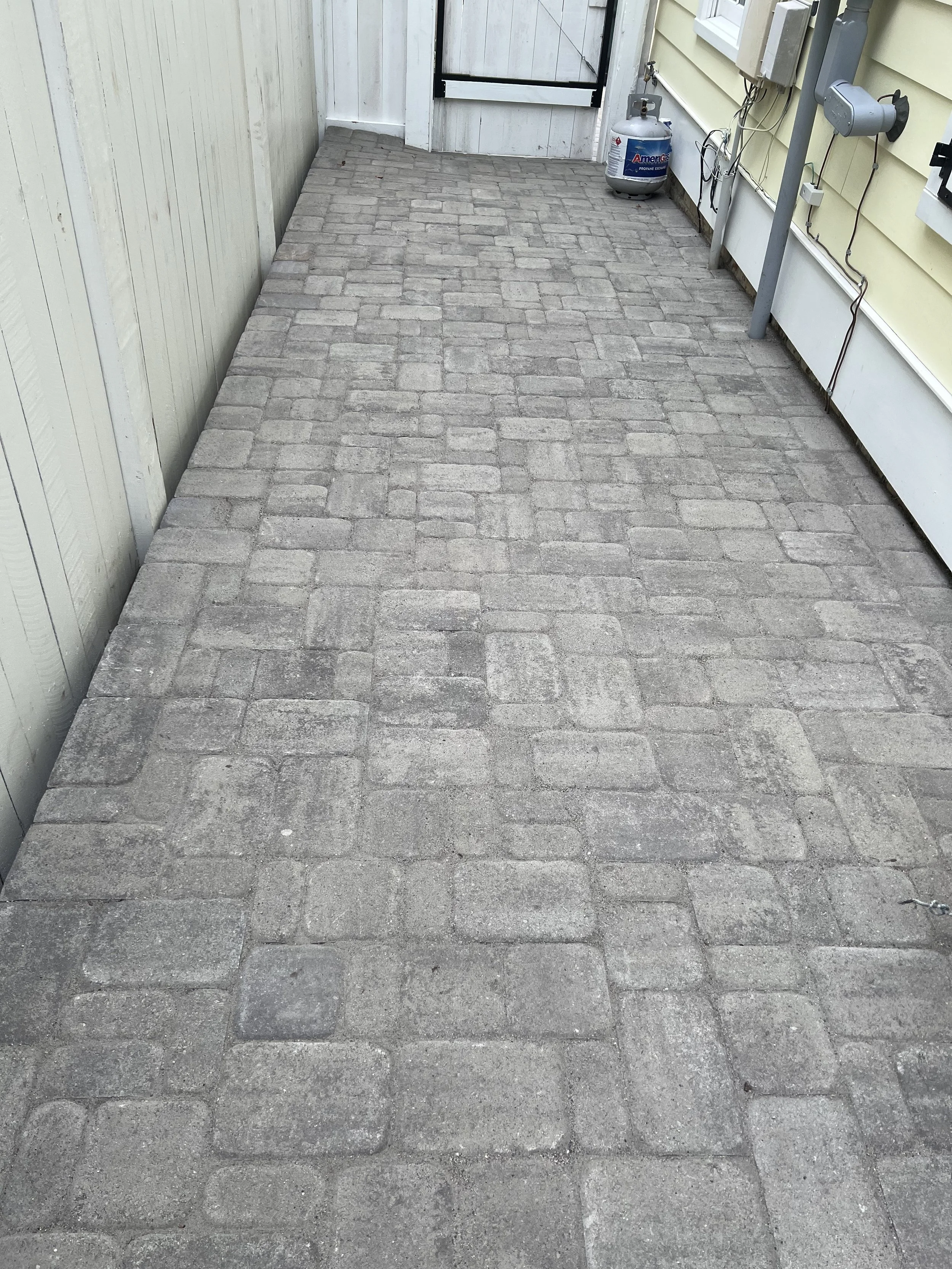 After — Paver patio finished with polymeric sand for clean, locked joints and long-term stability.