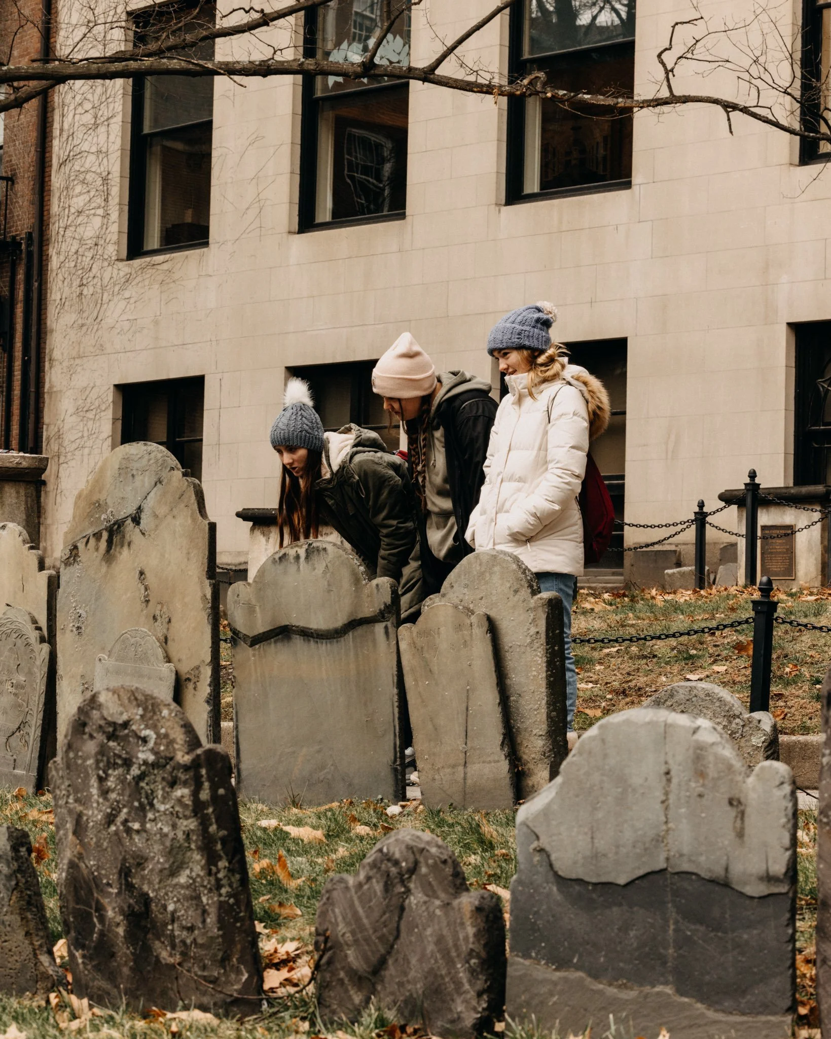students stand reading the graves at granary