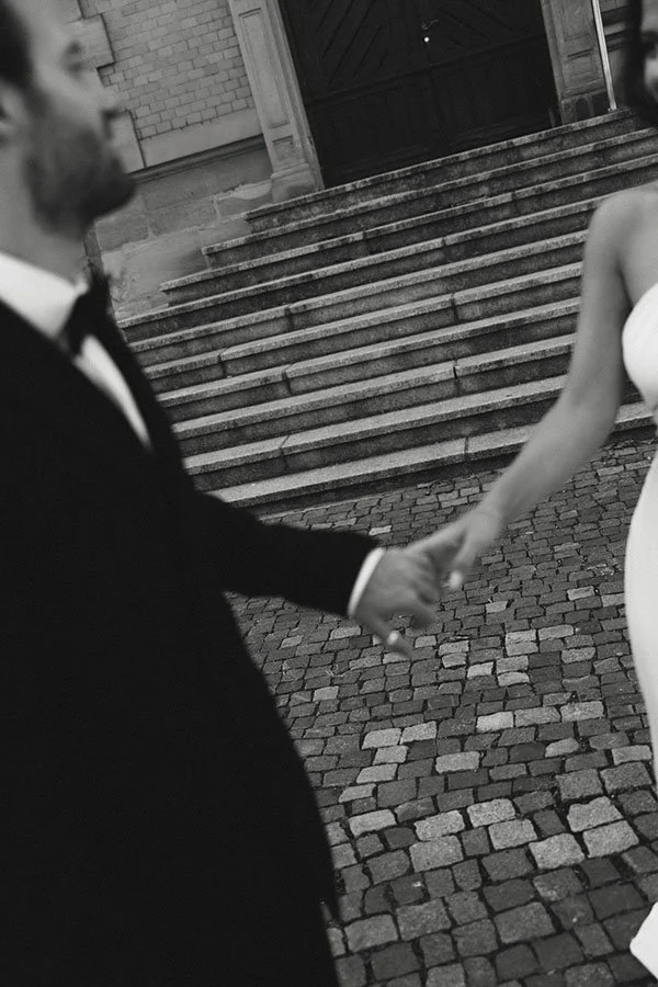 details of bride and groom holding hands
