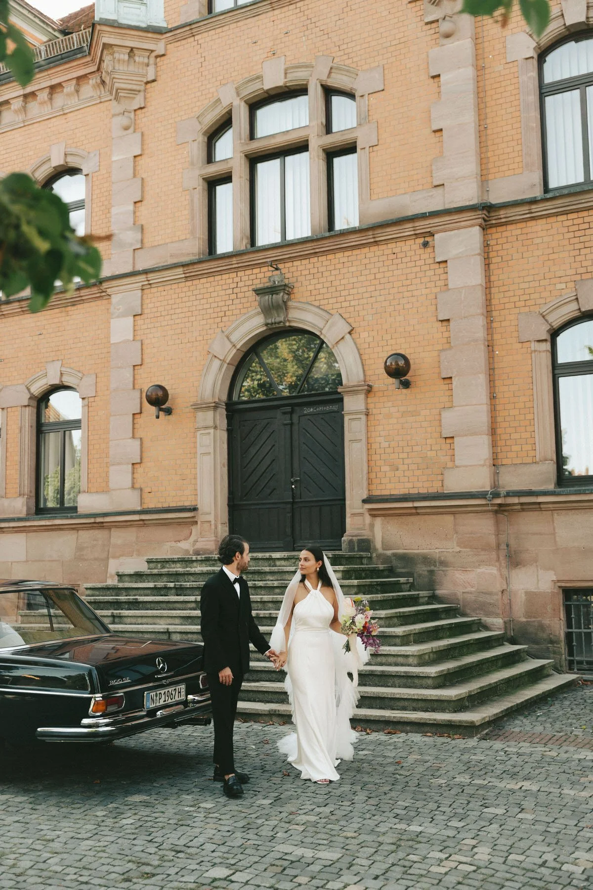 bride and groom with old-timer car after civil wedding