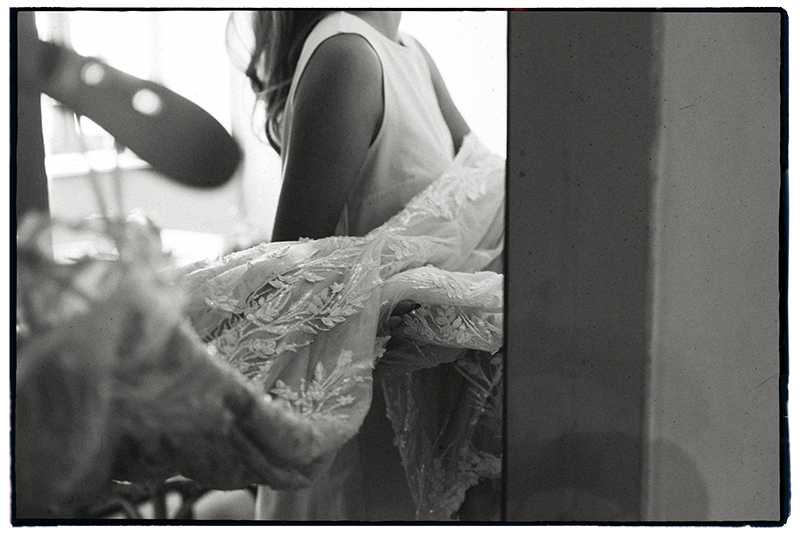 Wedding details of bride carrying her dress