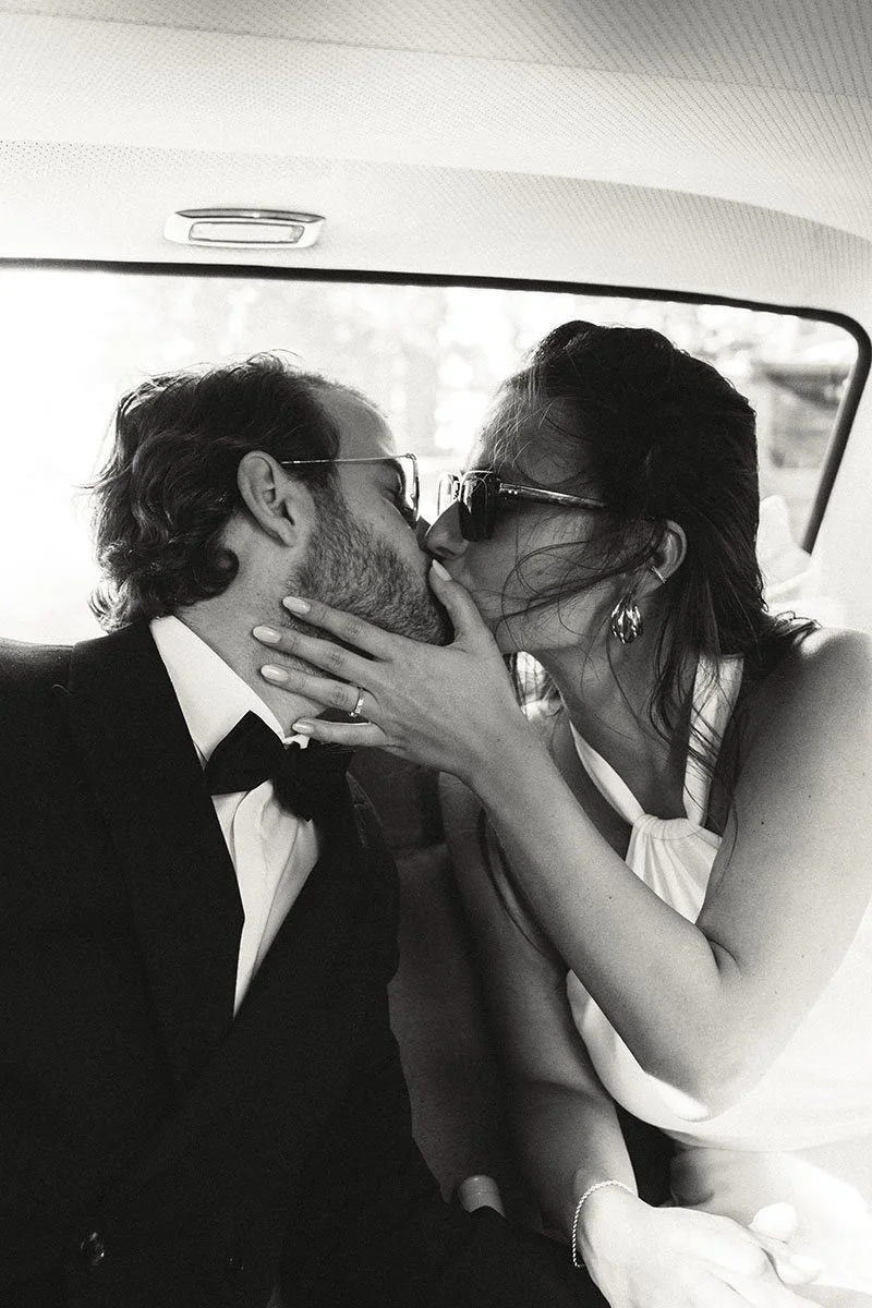 bride and groom kissing in the old-timer car