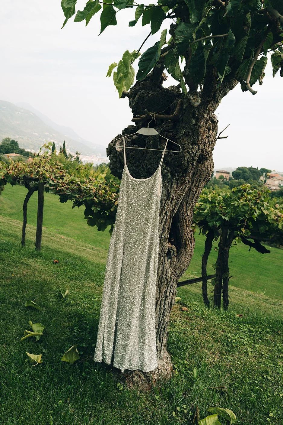 wedding dress hanging in the garden at lake Garda in Italy
