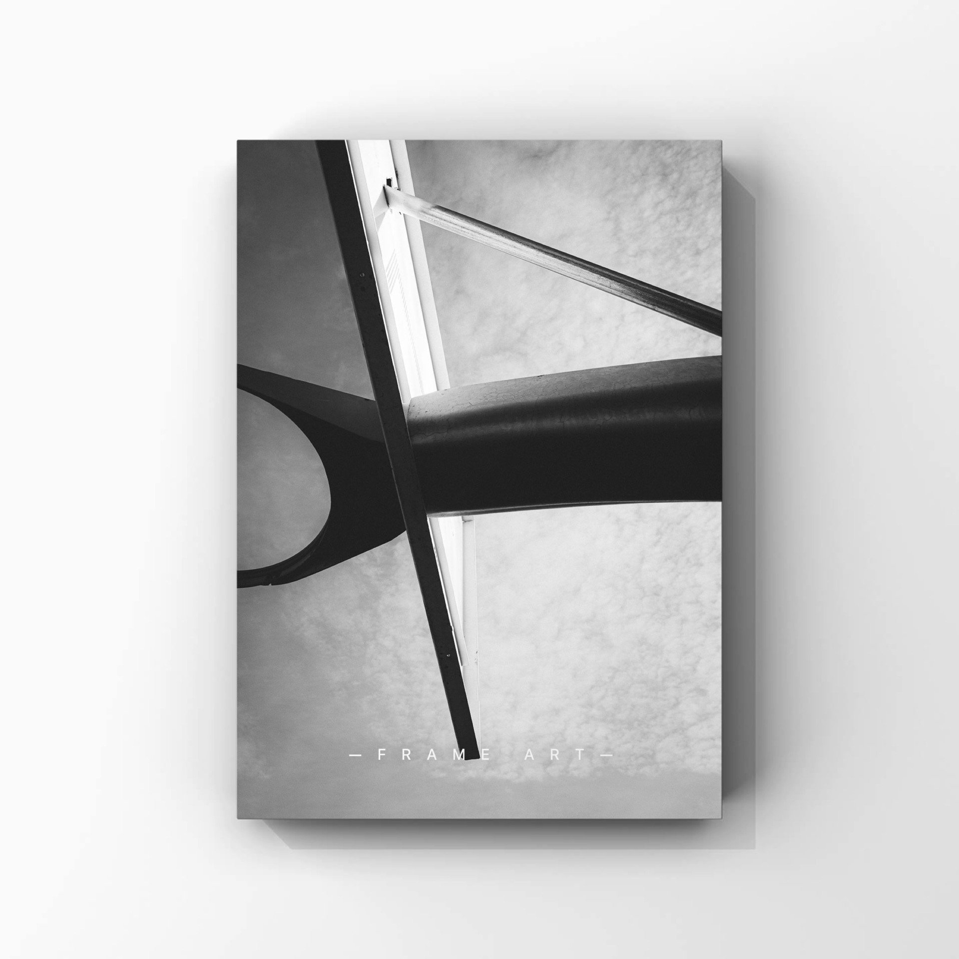 Black and white photo of a basketball hoop shot from below, looking up at the sky. The words 'Frame Art' are printed at the bottom.
