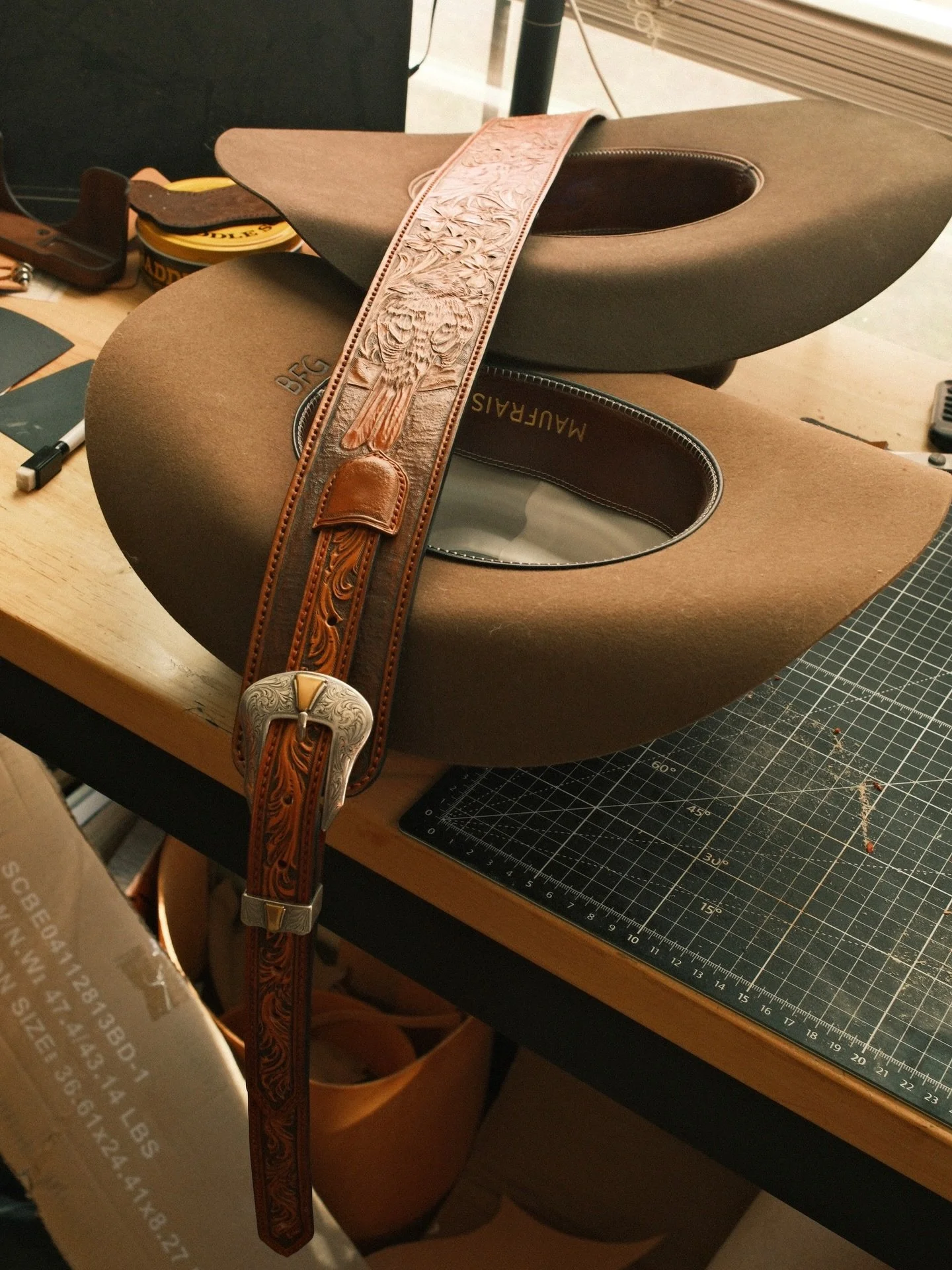 My cowboy hats were the safest place to put the new adjustable and fully tooled guitar strap I just finished. It&rsquo;s 650 if anyone wants to treat themselves 👀 38-47.5&rdquo; full tooling photos in natural light no adjusting to come tomorrow if y