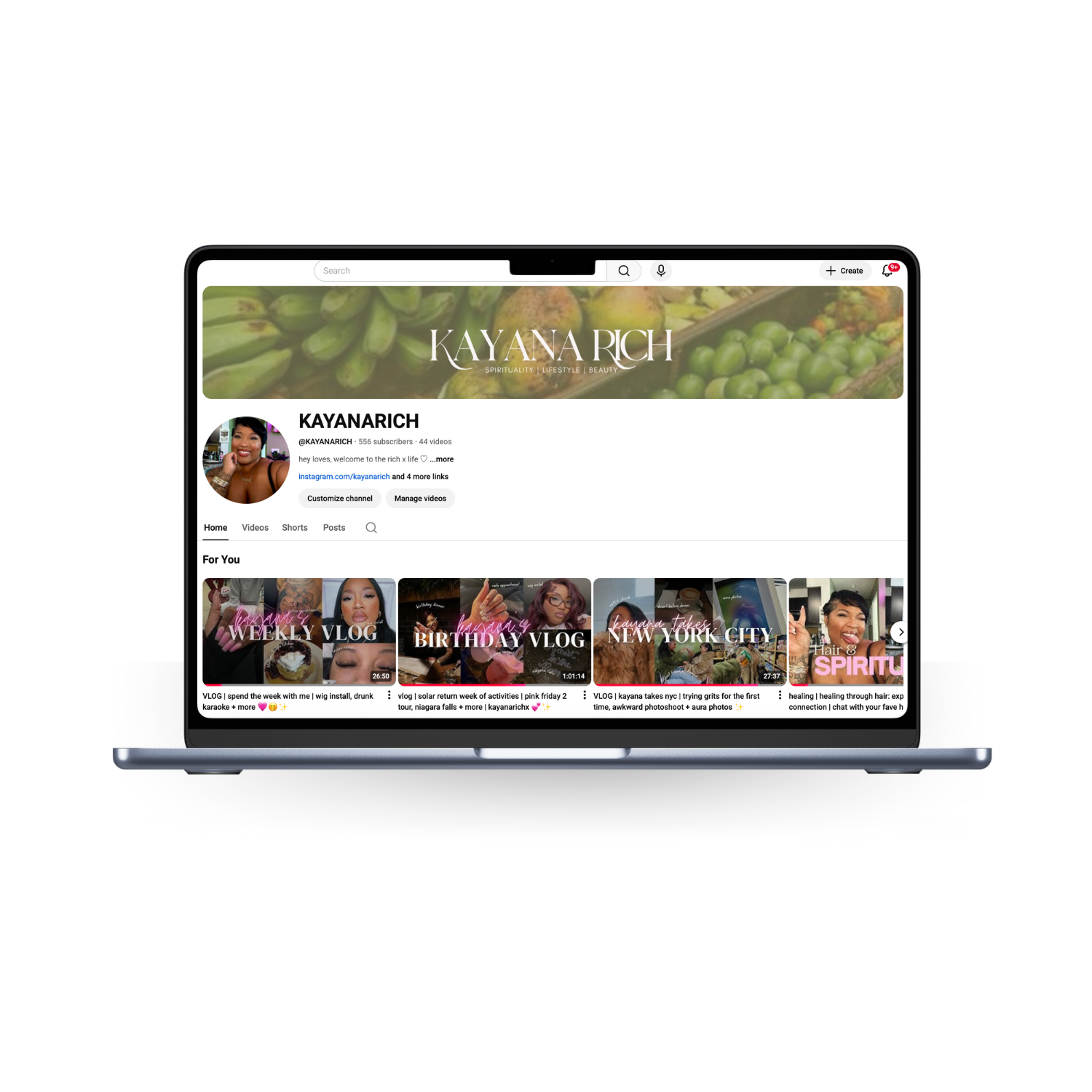 Laptop screen displaying a YouTube channel page for Kayana Rich, with a header banner featuring green produce and a profile picture of a smiling woman. The channel has various video thumbnails, including weekly vlogs, birthday vlogs, and city trips.