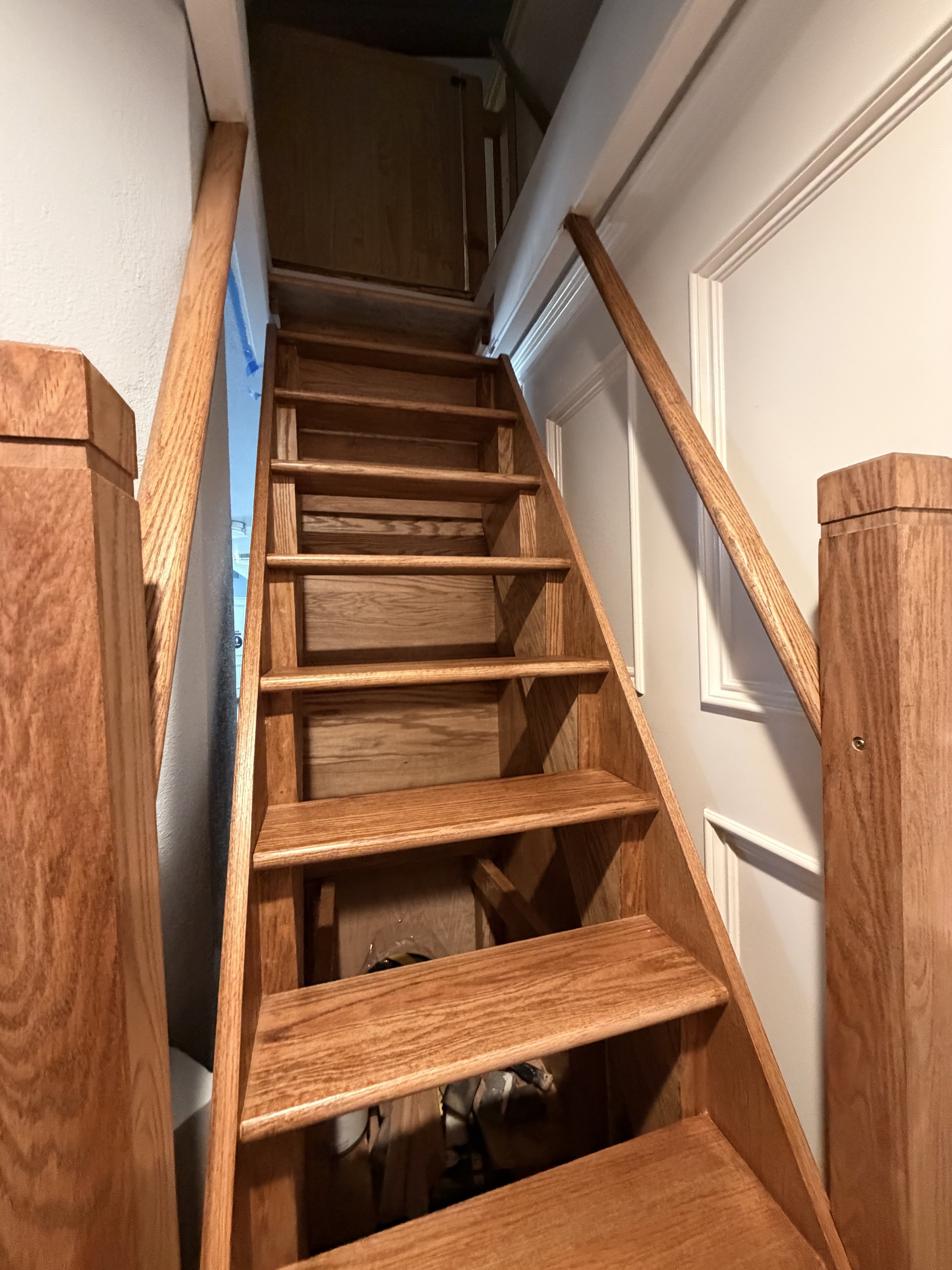 Stained wood staircase with new newel posts